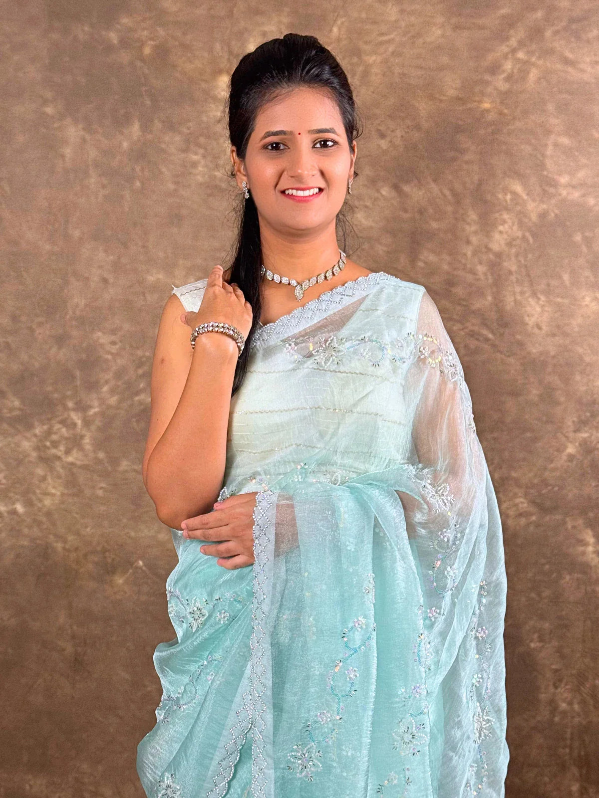 Tarani close-up of light blue organza saree showing upper body drape and neckline embroidery