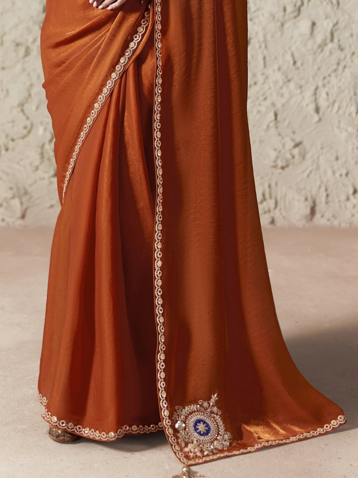 Tarani rust orange organza saree pallu and embroidered border detailing closeup