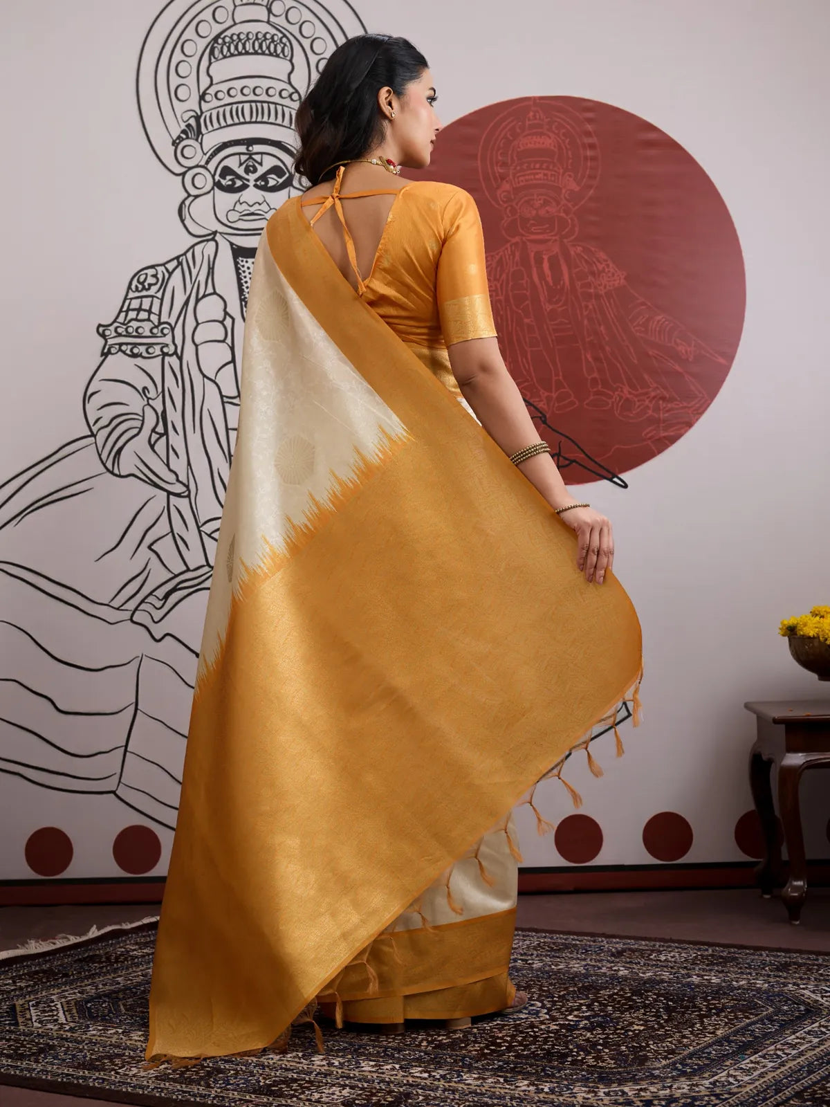 Tarani back view of paper silk saree showing golden pallu and tie-back blouse