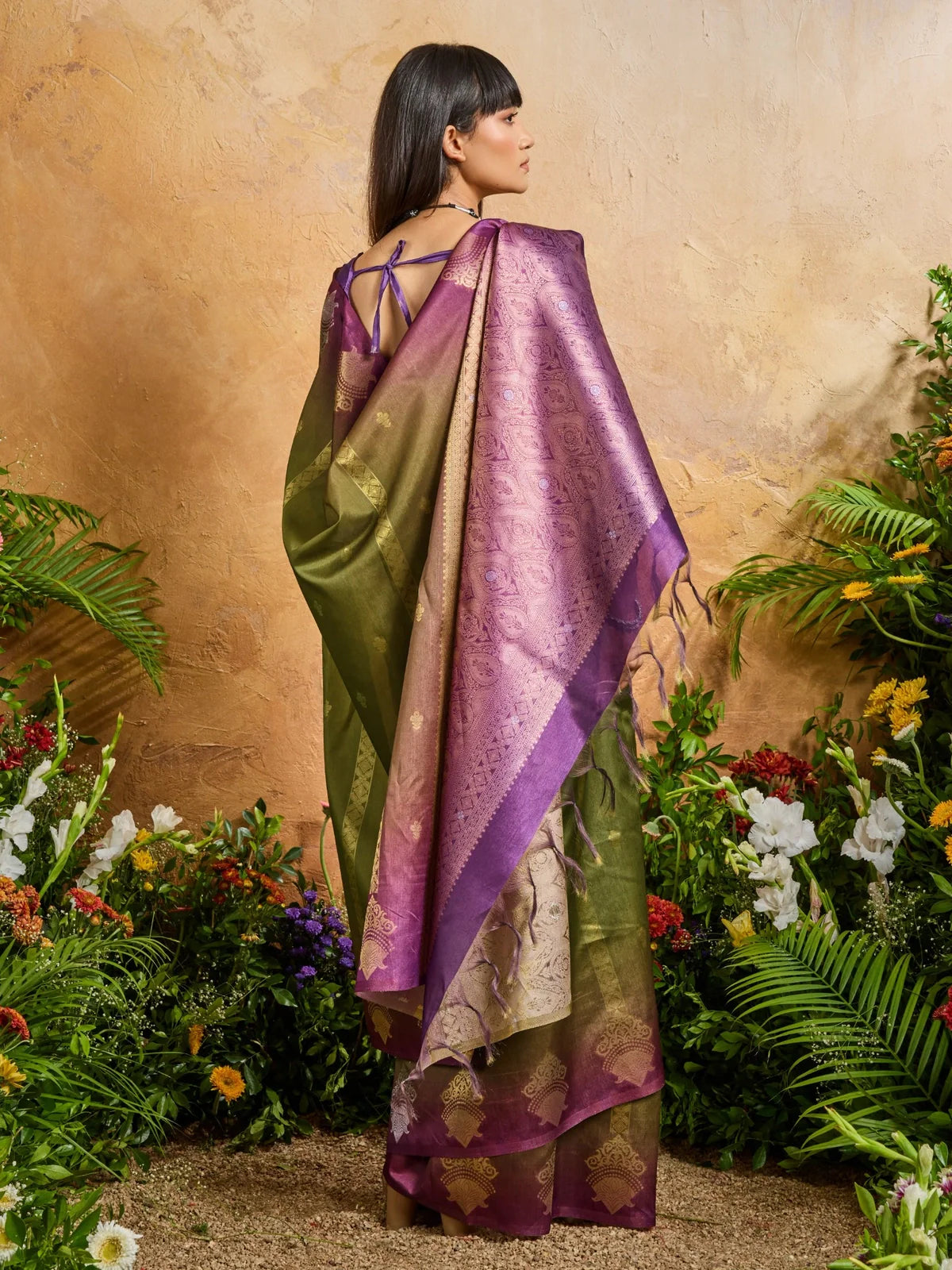 Tarani back view of paper silk saree with traditional motifs and tie-back blouse