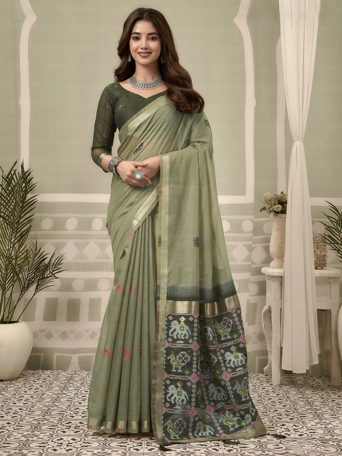 Tarani green patola saree with zari border and fancy tassels full-view