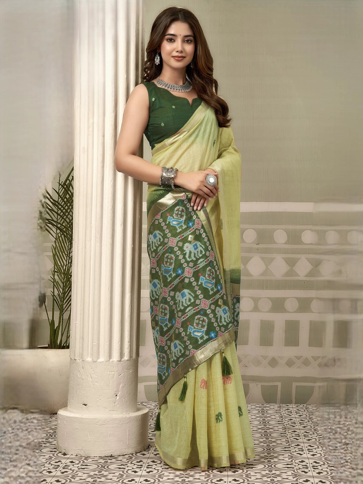 Tarani light green Patola saree side view with elegant zari border and tassels