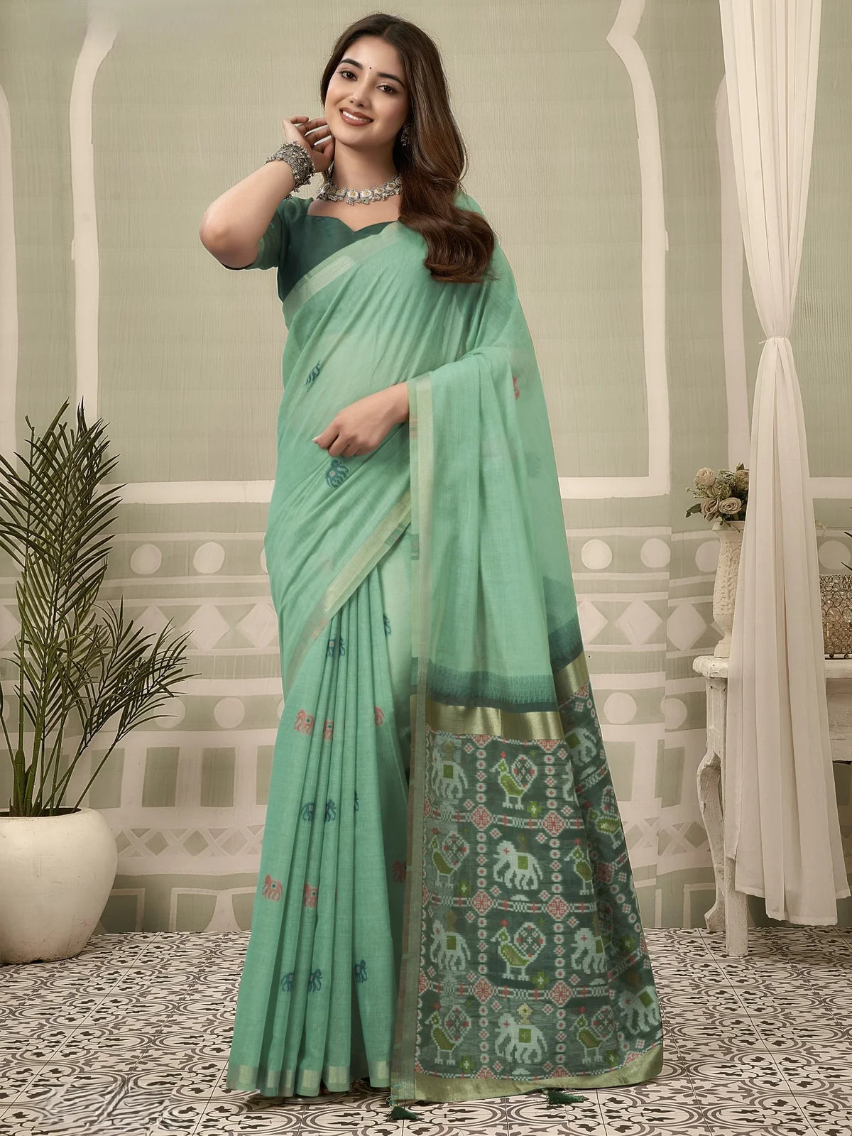 Tarani mint green Patola saree full view with zari border and fancy tassels