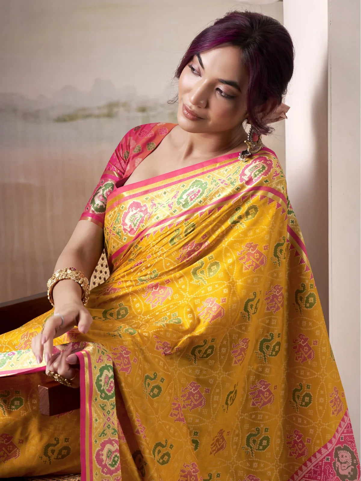 Tarani patola silk yellow saree side pose view highlighting motifs and elegant drape