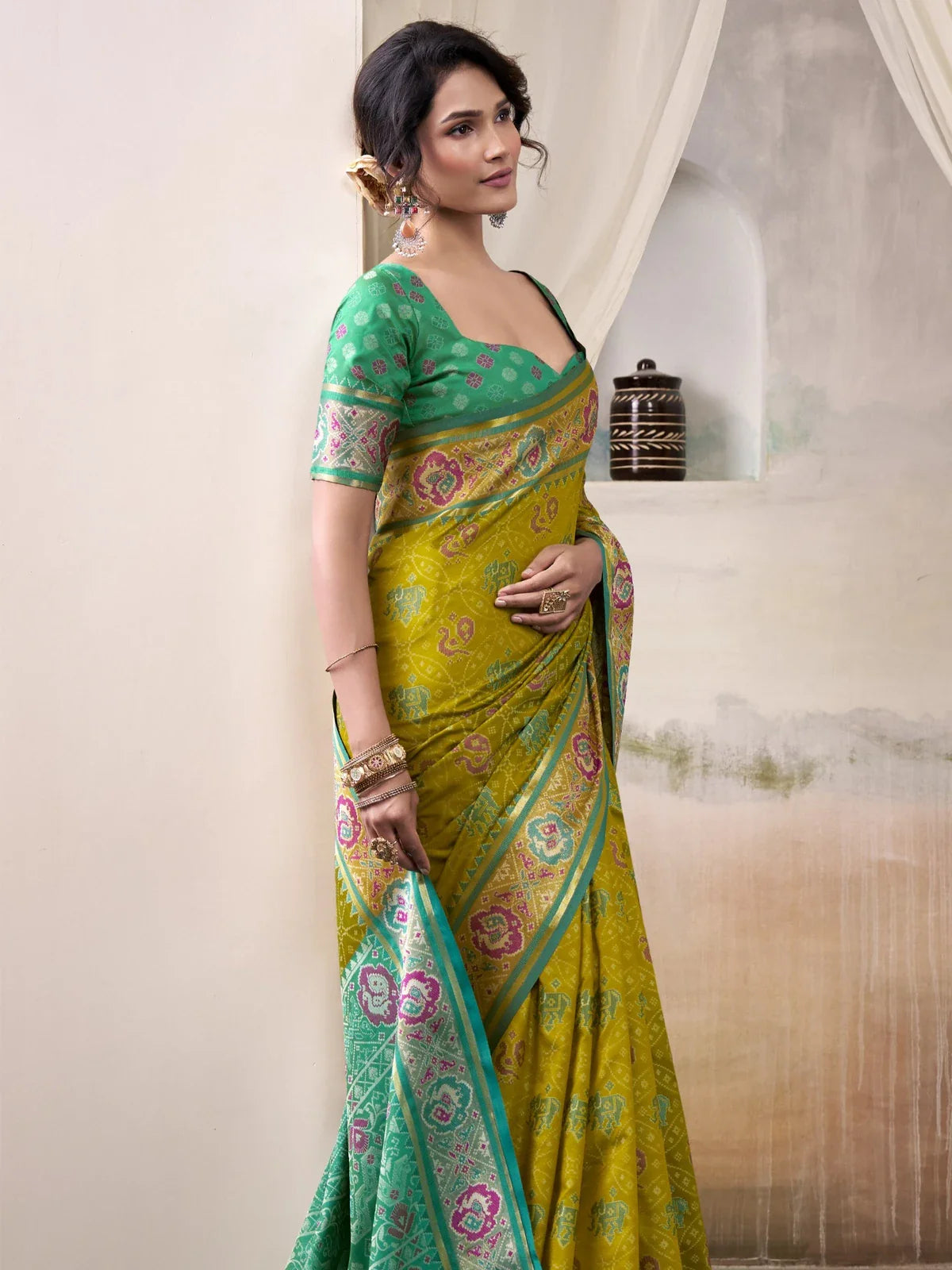Tarani yellow patola silk saree side view with elegant motifs and border