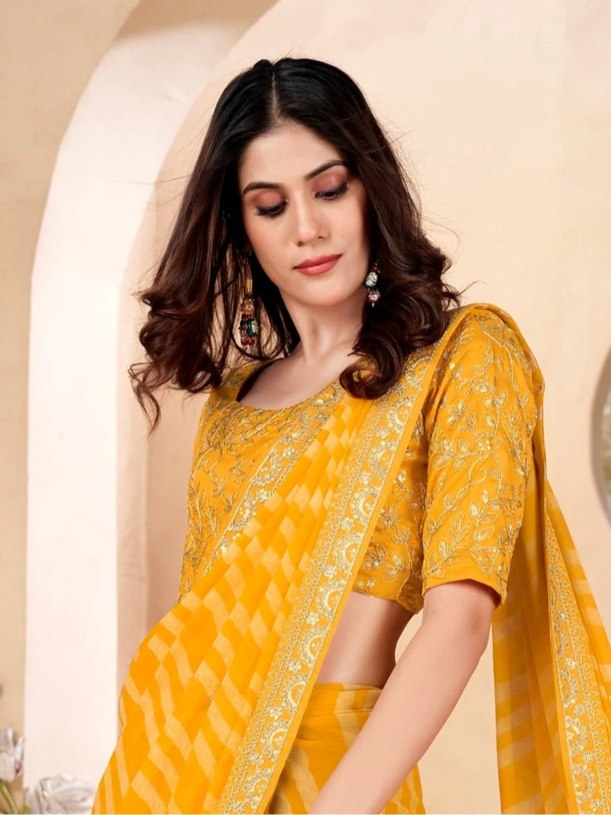 Tarani yellow festive poly georgette saree upper body close-up showing blouse embroidery