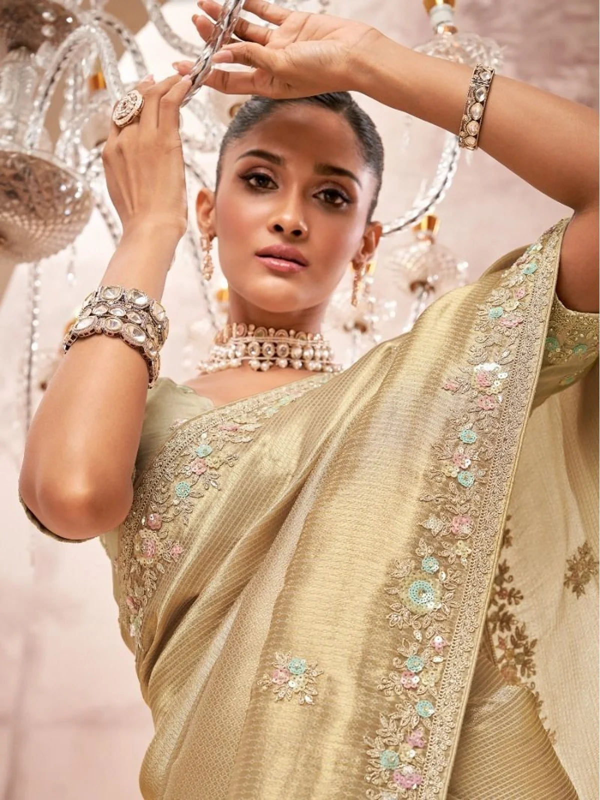 Tarani premium golden saree showing blouse work and jewellery in upper-body pose