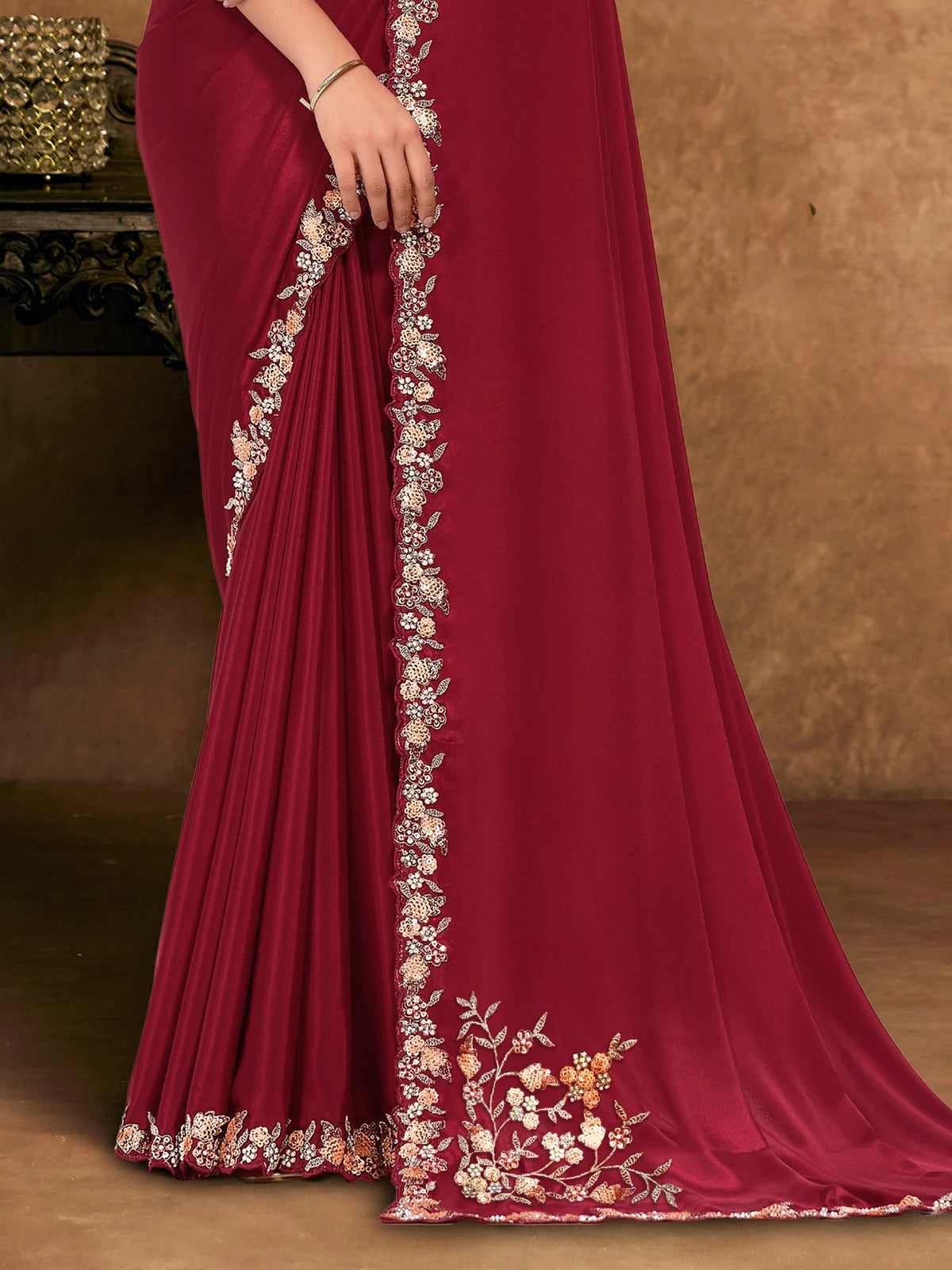 Tarani Jinala pallu view with floral embroidered border on maroon Pure Crepe Georgette saree