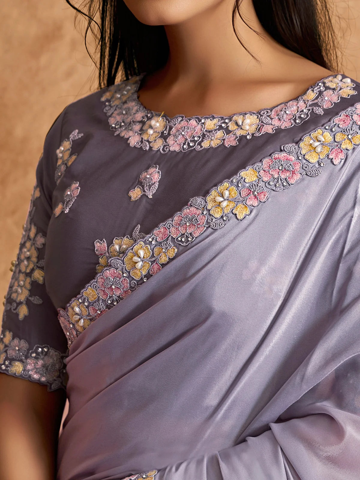 Tarani closeup view of floral embroidery and pearl detailing on lavender saree