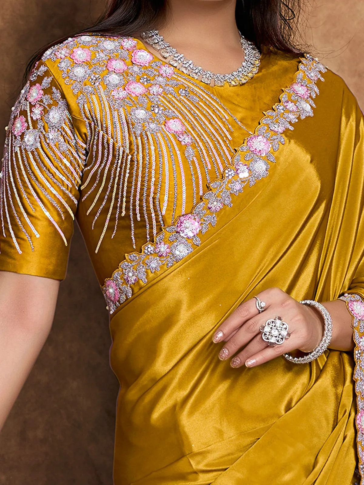 Tarani Samidha closeup view of floral pearl handwork border on mustard Pure Crepe Satin saree