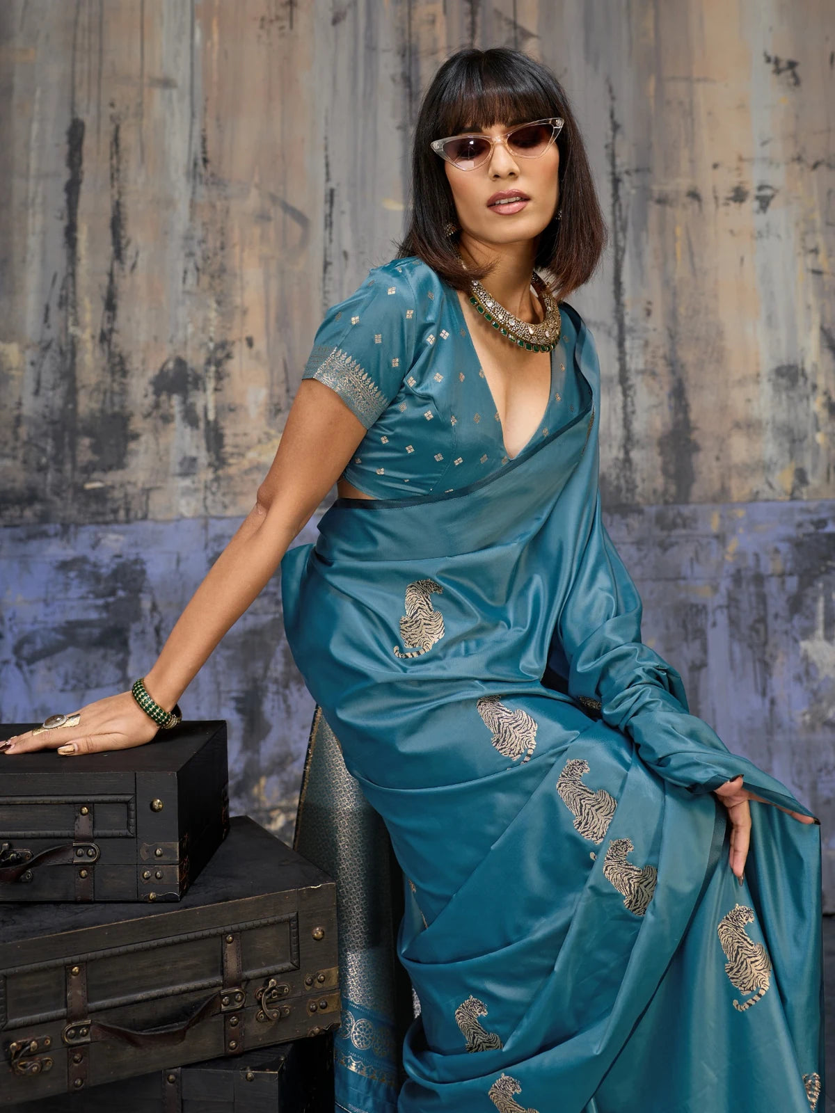 Tarani teal satin handloom saree closeup with tiger woven motifs and premium festive styling