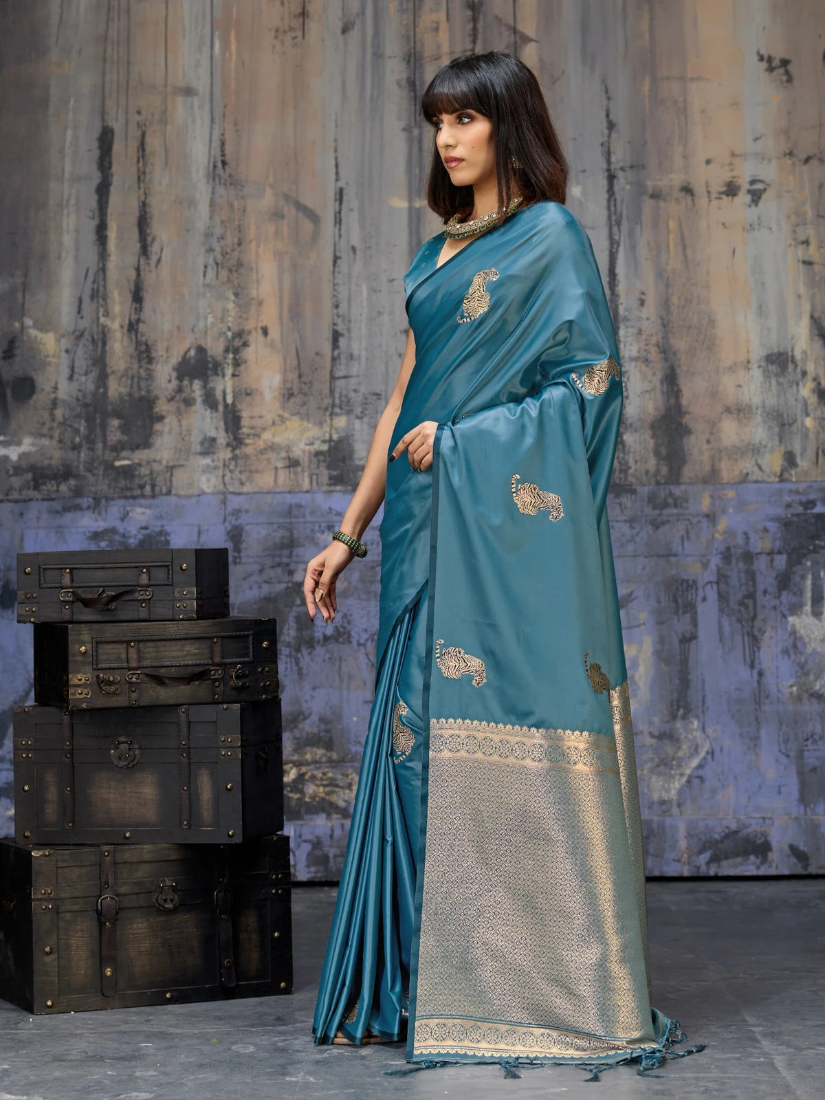Tarani teal woven satin saree showcasing luxurious pallu border and graceful festive look