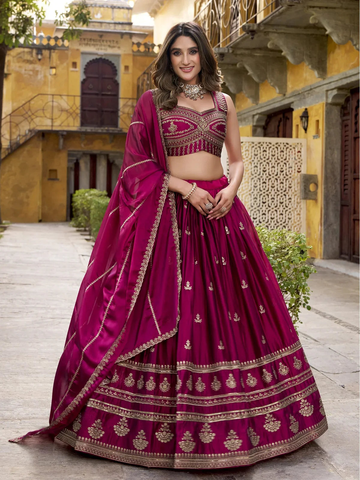 Tarani magenta rangoli lehenga front view with intricate hem and graceful silhouette