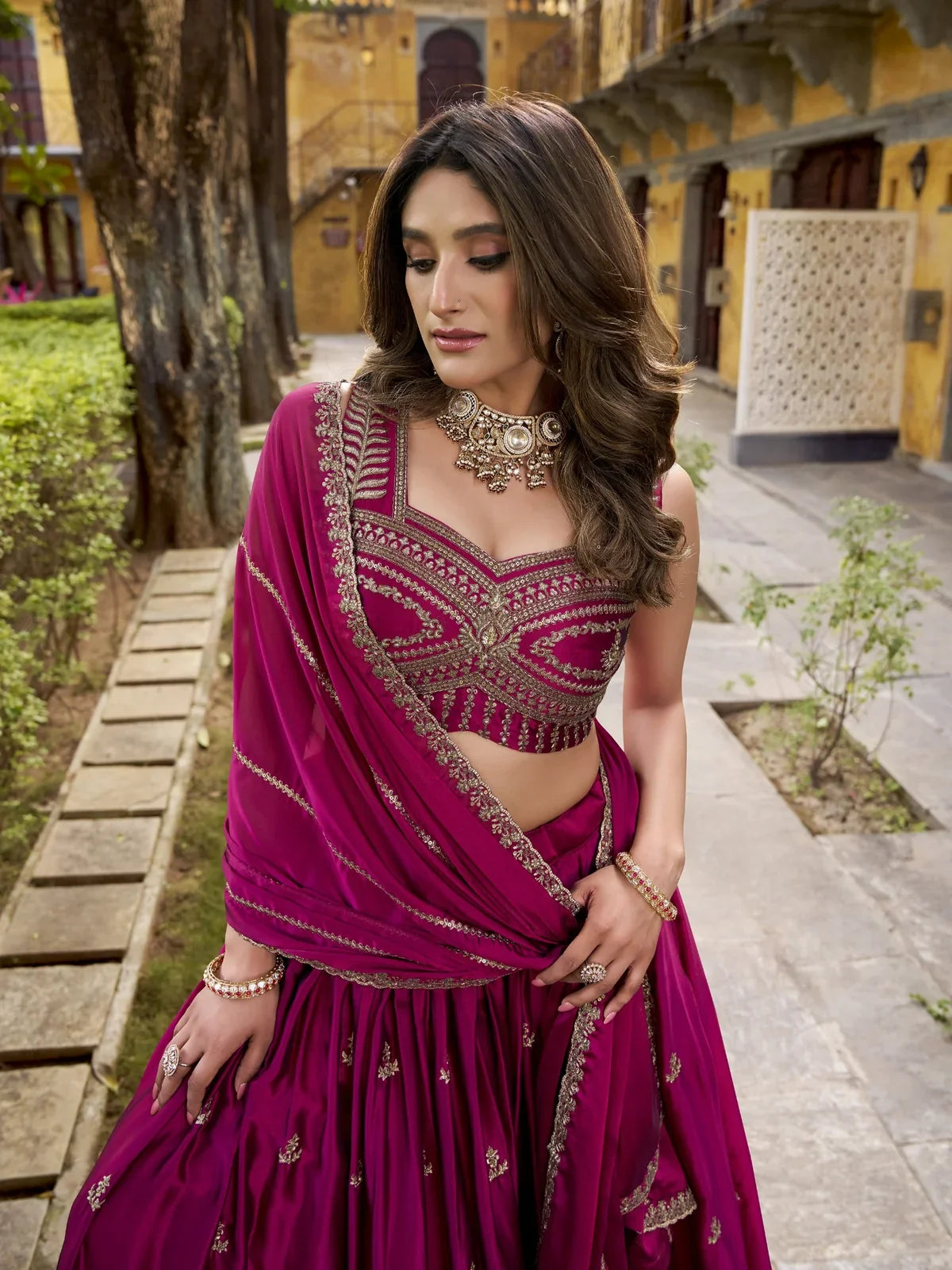 Tarani upper body view showing sequin and thread embroidery blouse of magenta lehenga
