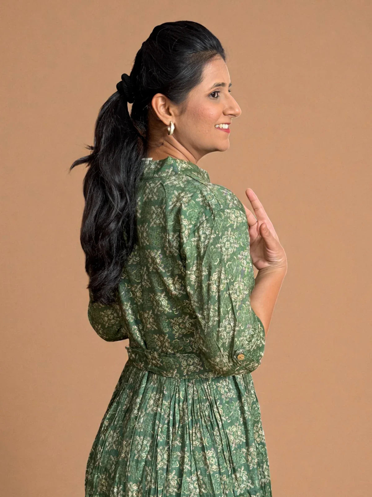 Tarani green rayon midi dress back view with elegant belt and gathered pleats