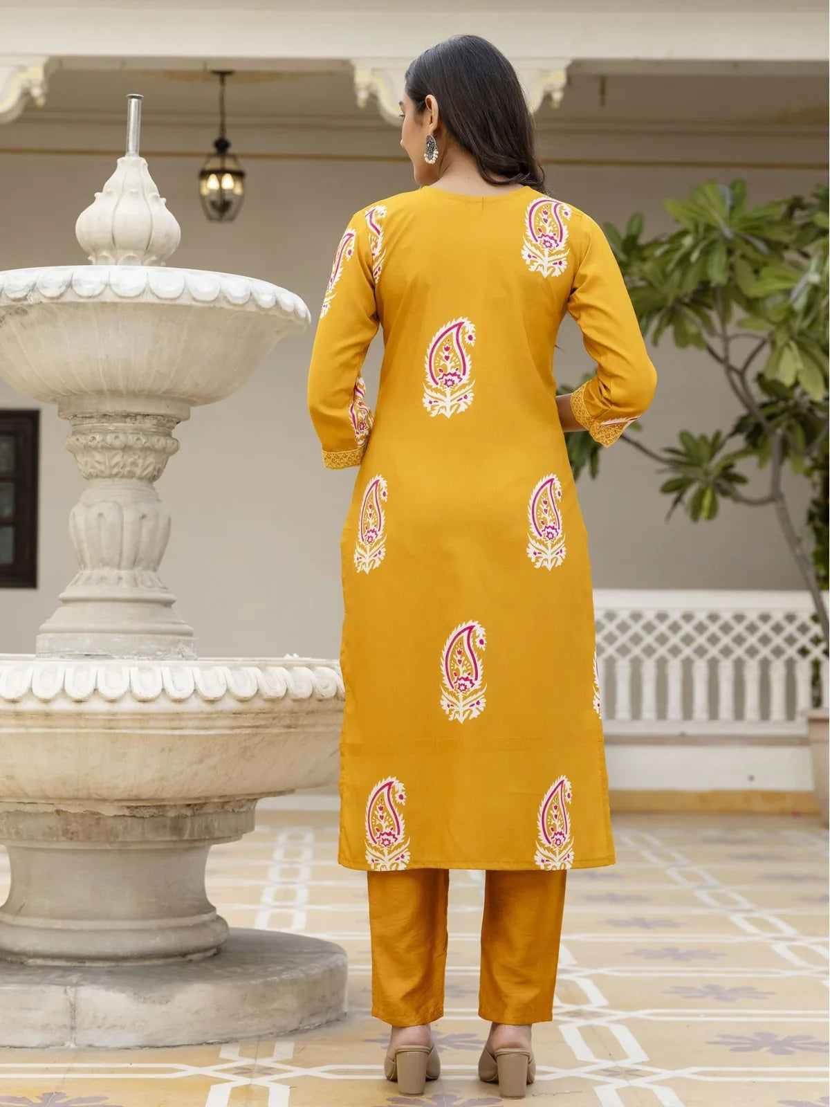Back view of Tarani festive mustard rayon dress with printed motifs and straight-cut fit