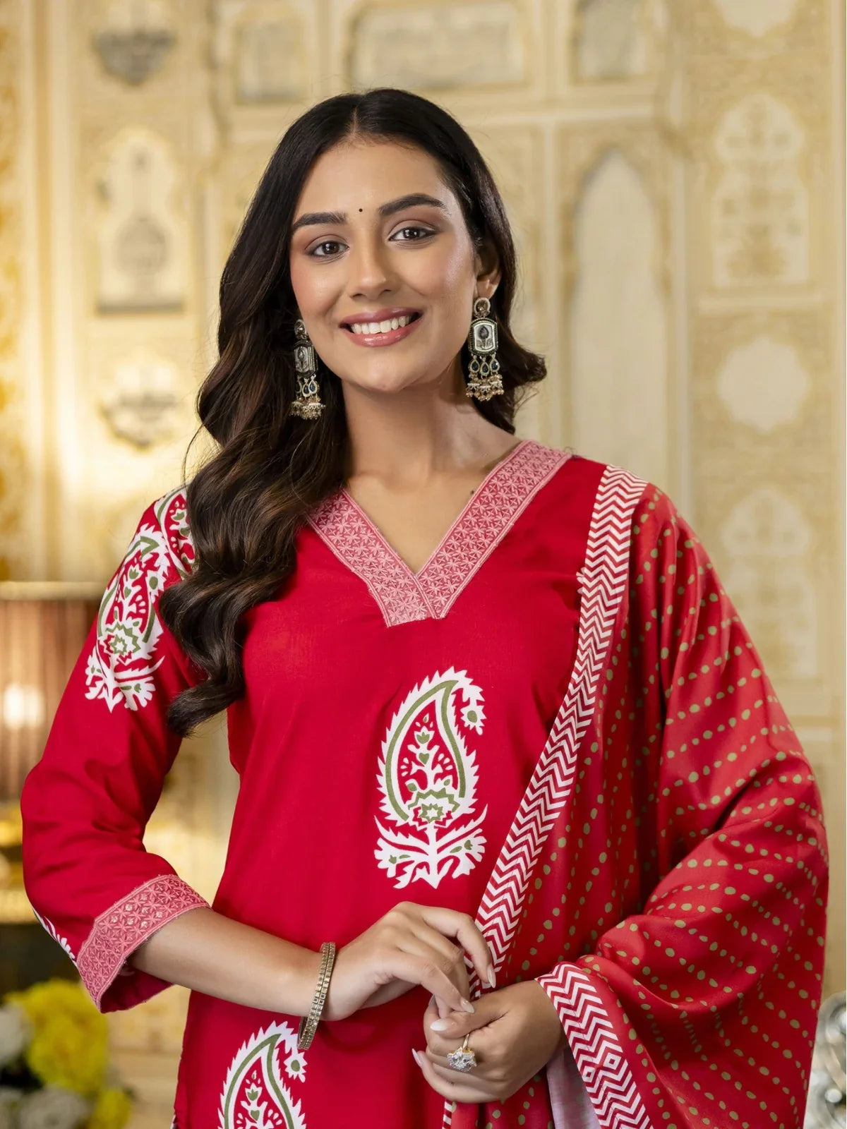 Tarani red rayon dress close-up showing neckline and upper printed detailing with earrings