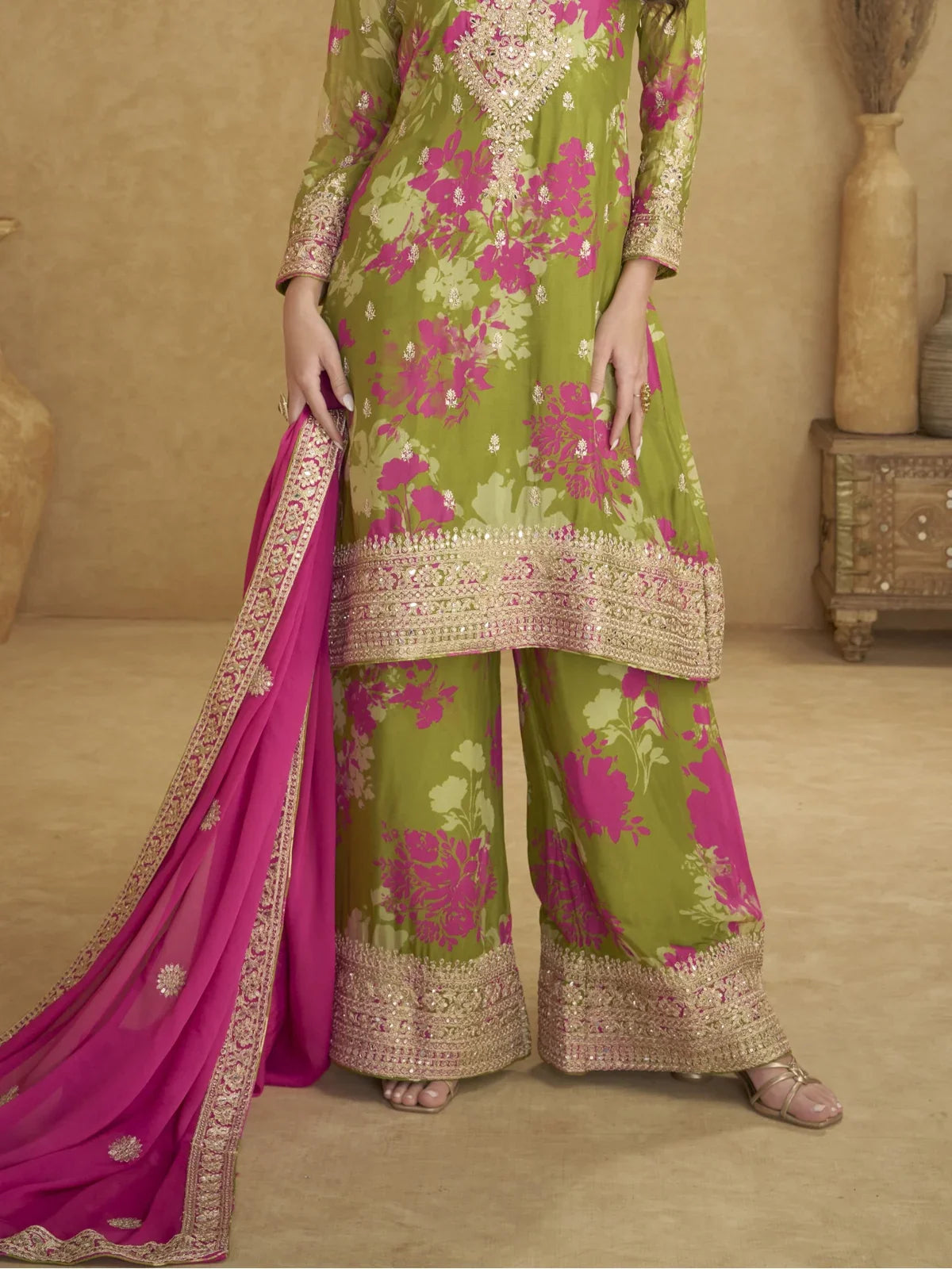 Tarani closeup of embroidered neckline and pink floral design on green chinon suit