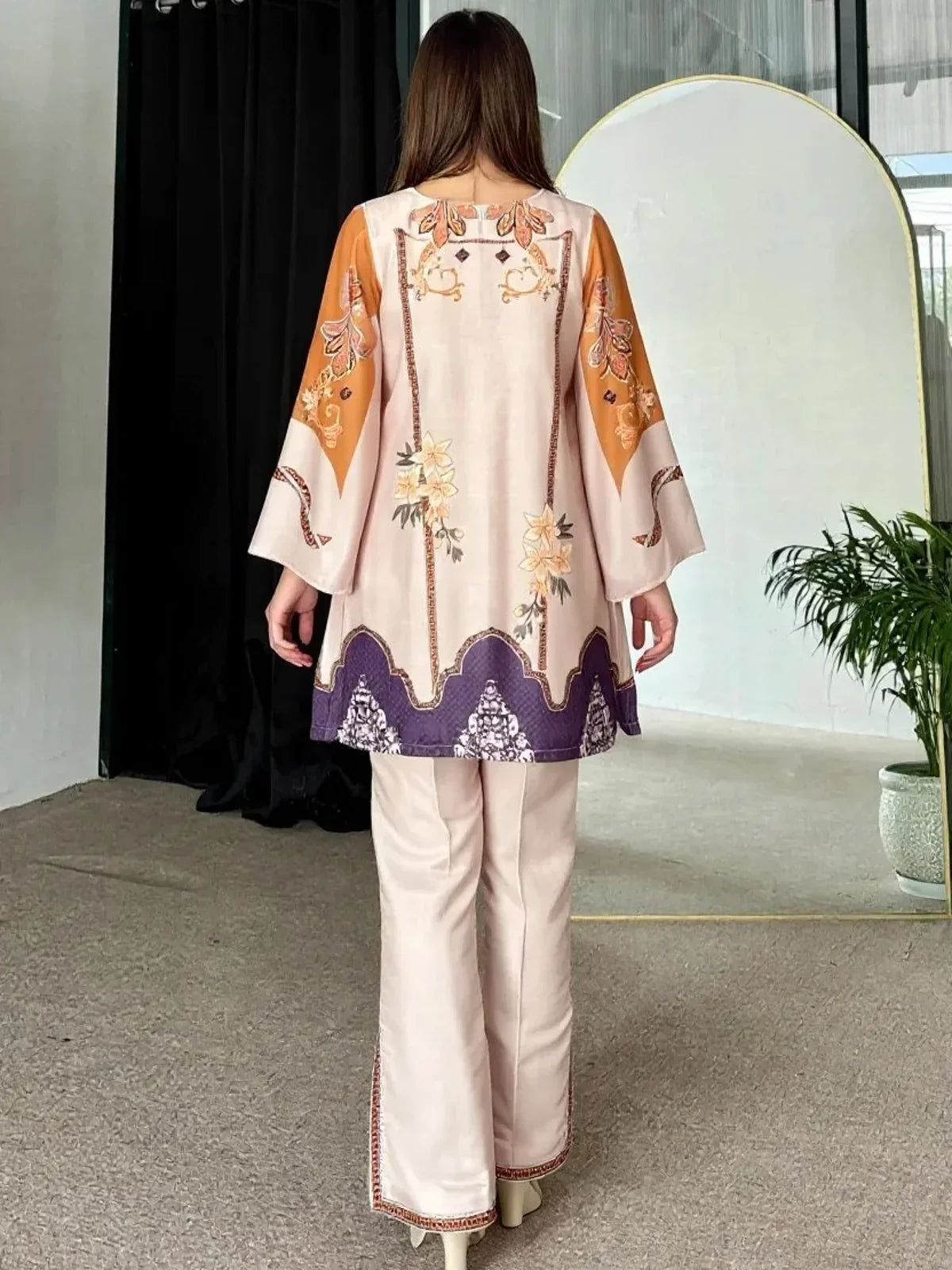 Back view of Tarani beige reyon kurti with floral print and embroidered hem