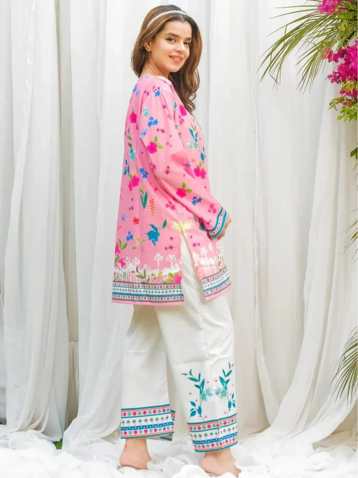 Tarani pink festive wear reyon dress side pose with soft silhouette and printed borders