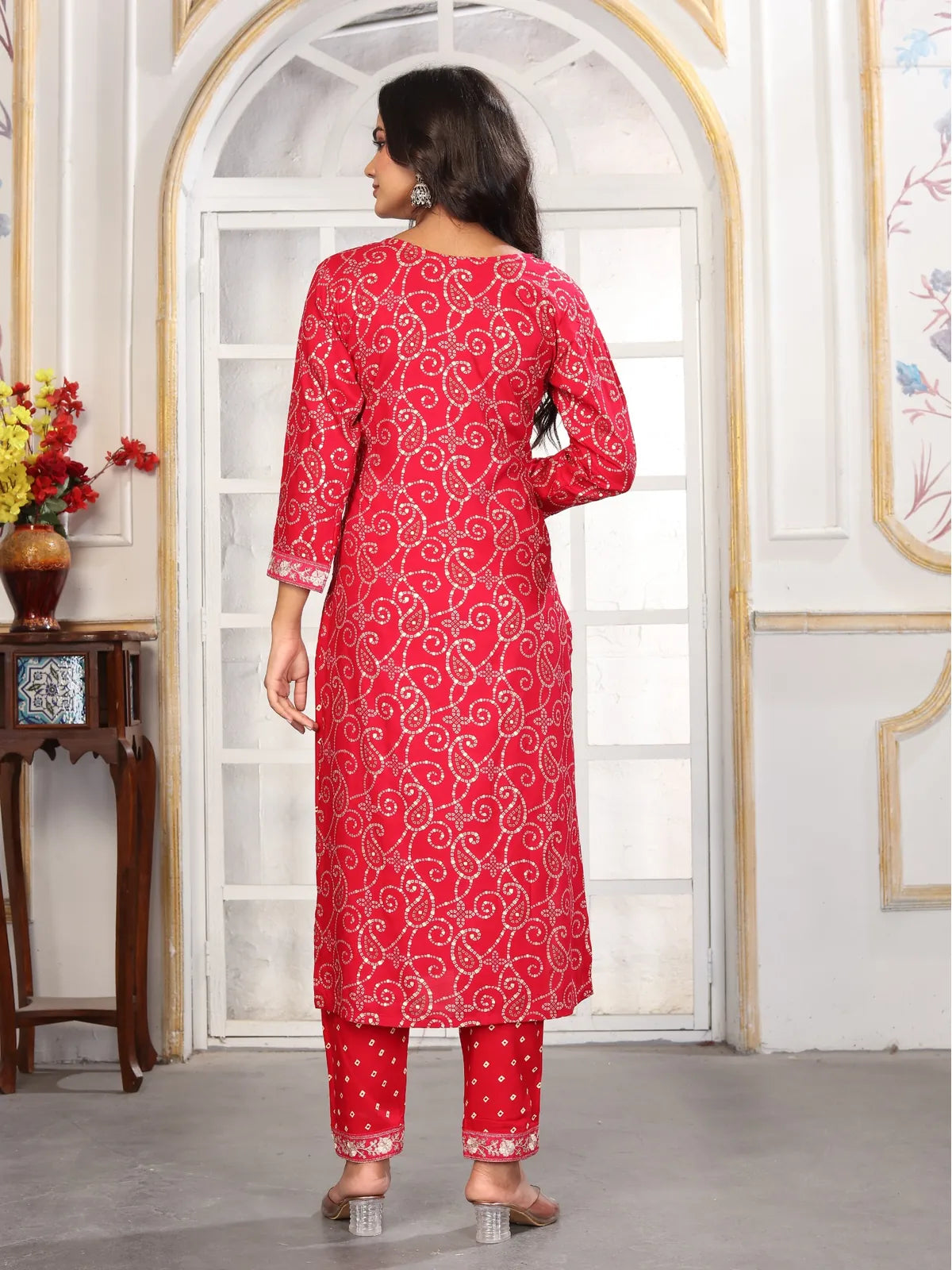 Back view of Tarani red riyon embroidered dress with traditional swirl patterns