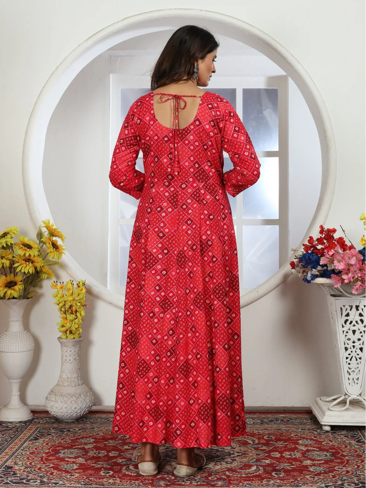 Tarani red riyon gown back view with tie-up detail and graceful fall
