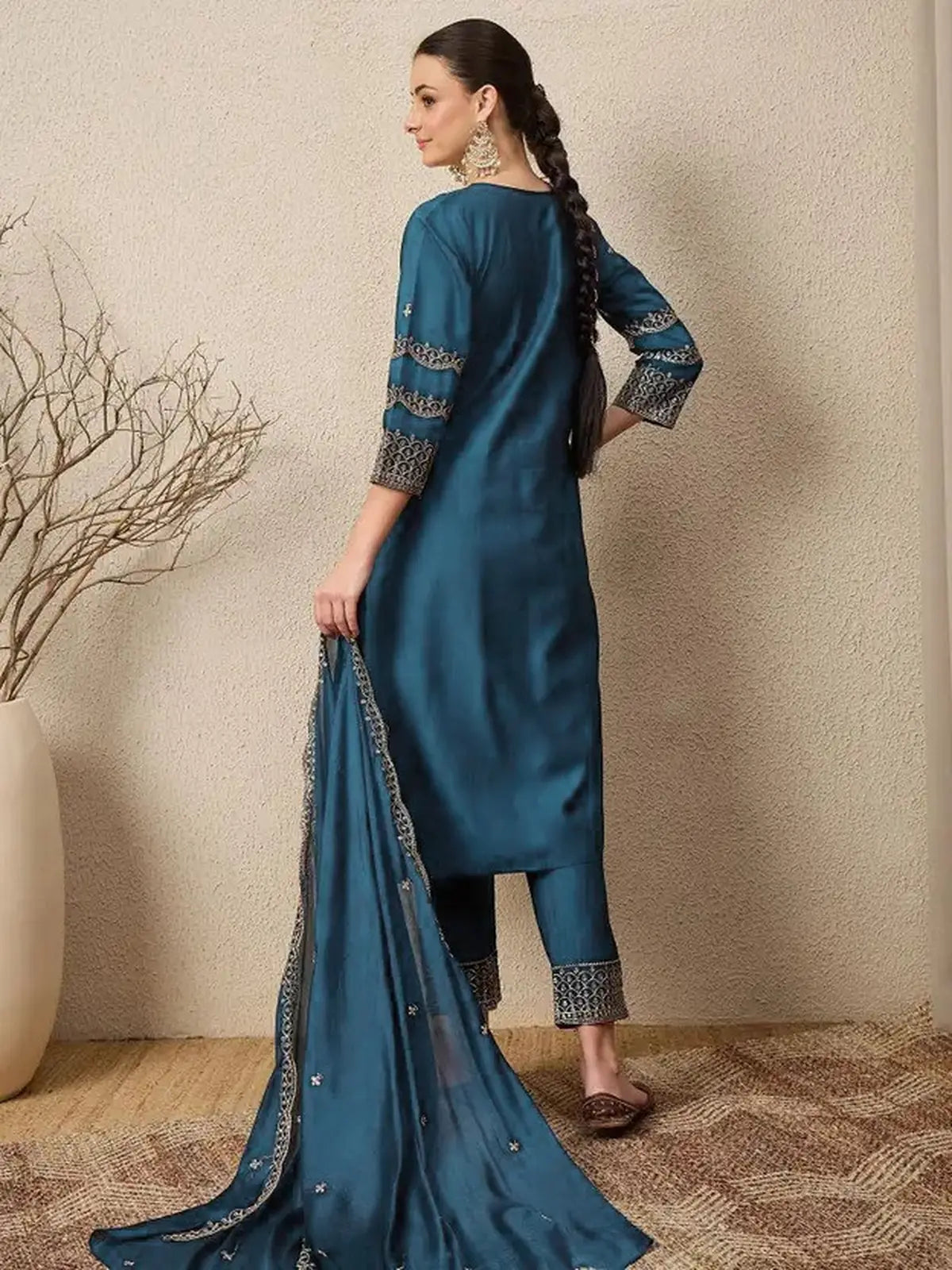 Tarani Roman dress back pose showing sleeve work and dupatta fall in teal color