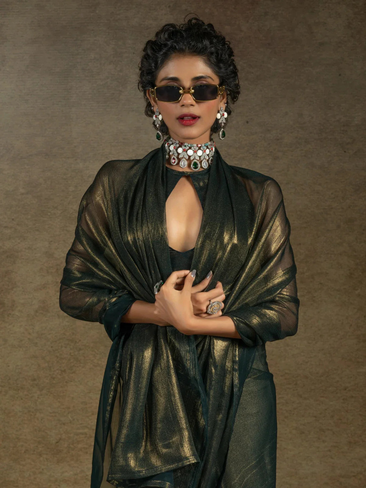 Tarani premium satin chiffon saree in green with glamorous upper body styling and jewellery