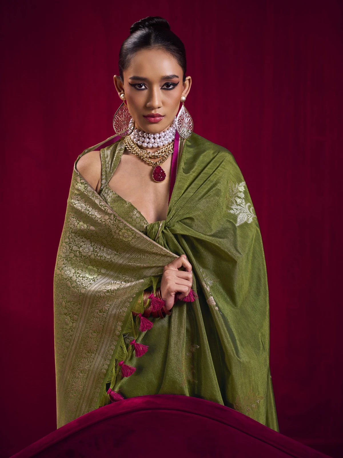Tarani olive green weaving silk saree with rich pallu and tassel detailing for festive occasions