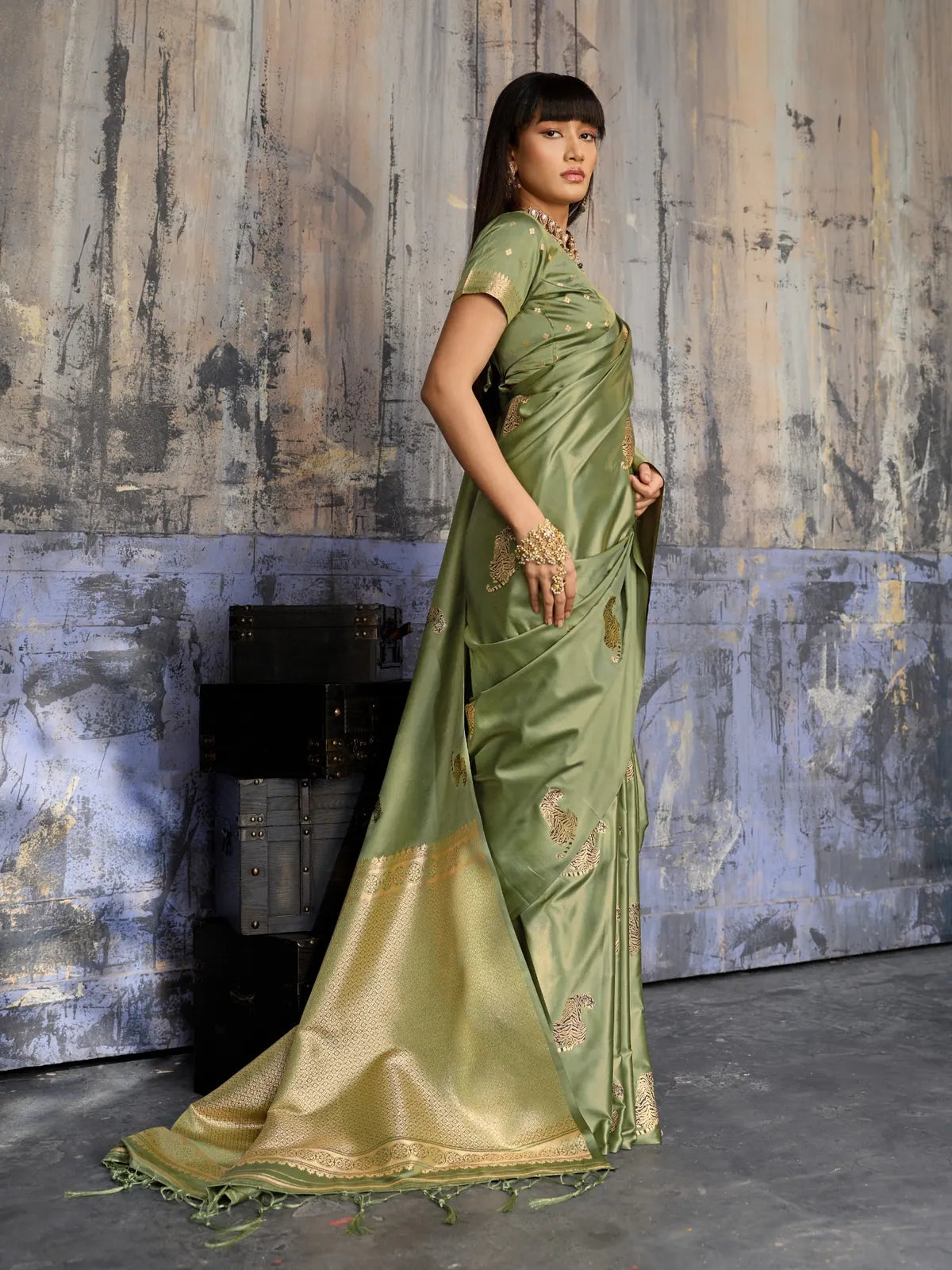 Tarani olive green handloom saree side pose with graceful woven motifs and soft shine