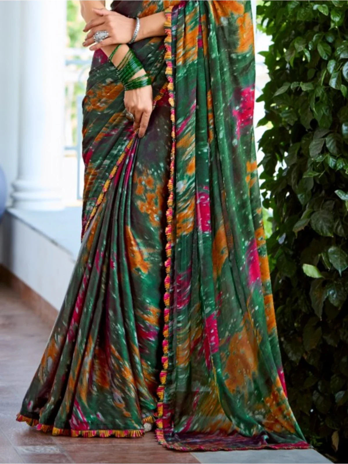 Tarani green satin saree front lower view showing drape and detailed festive patterns