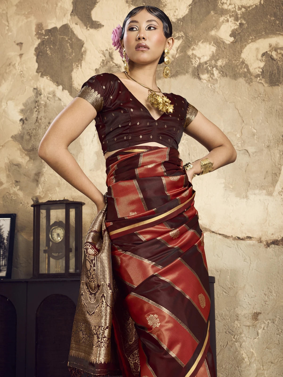 Tarani closeup of maroon satin saree pleats and woven detailing