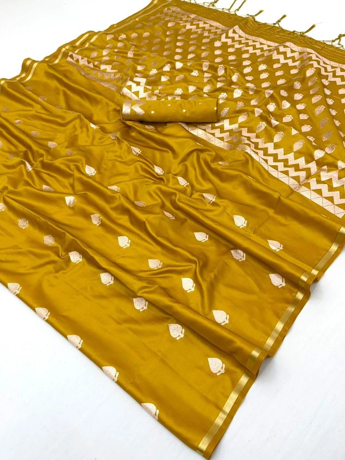 Tarani Leena mustard pure satin saree closeup showcasing woven motifs and luxurious texture