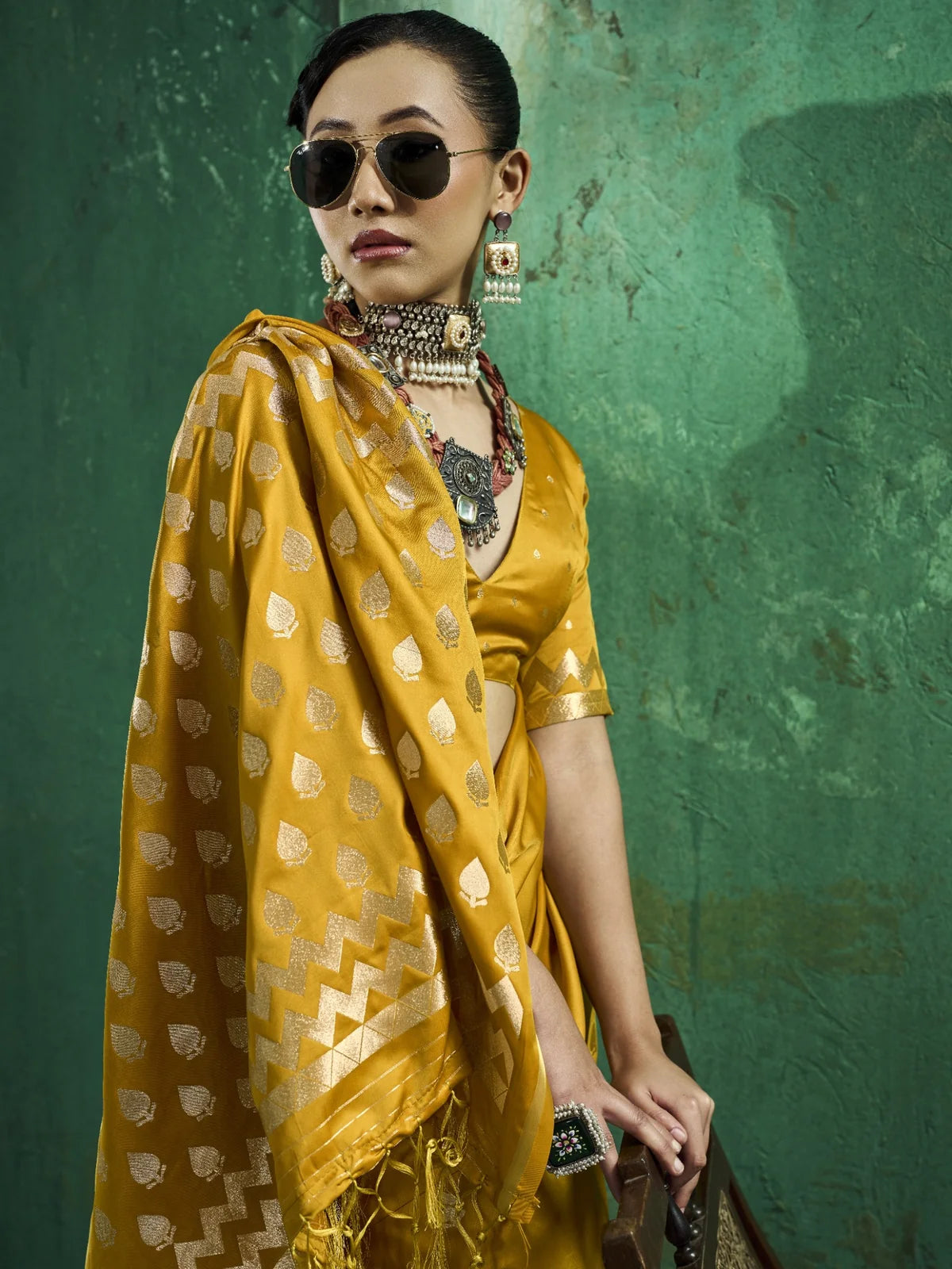 Tarani Leena mustard satin saree pallu view with zari border and woven motifs