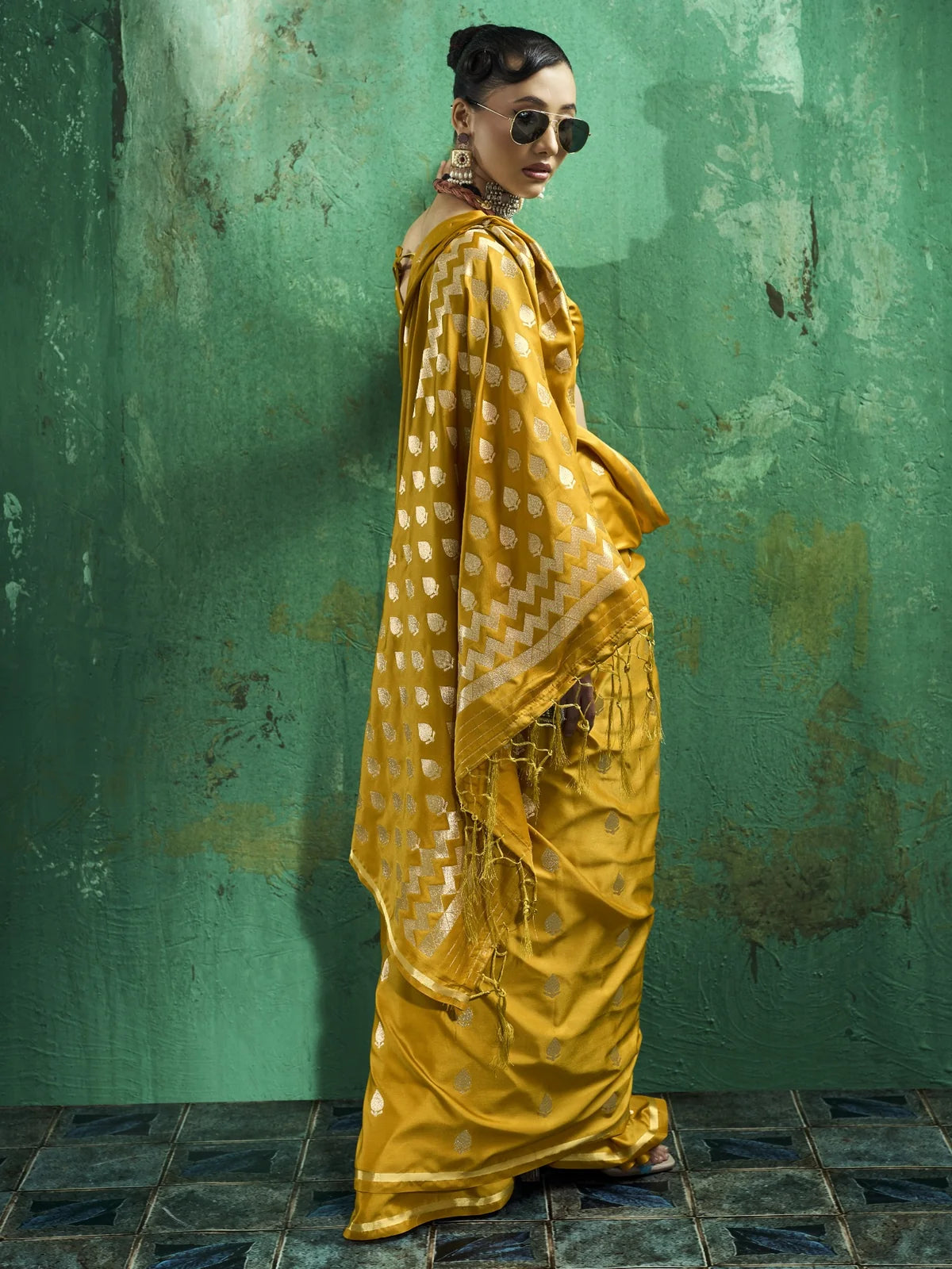 Tarani Leena mustard satin saree side view with rich pallu and tassel details