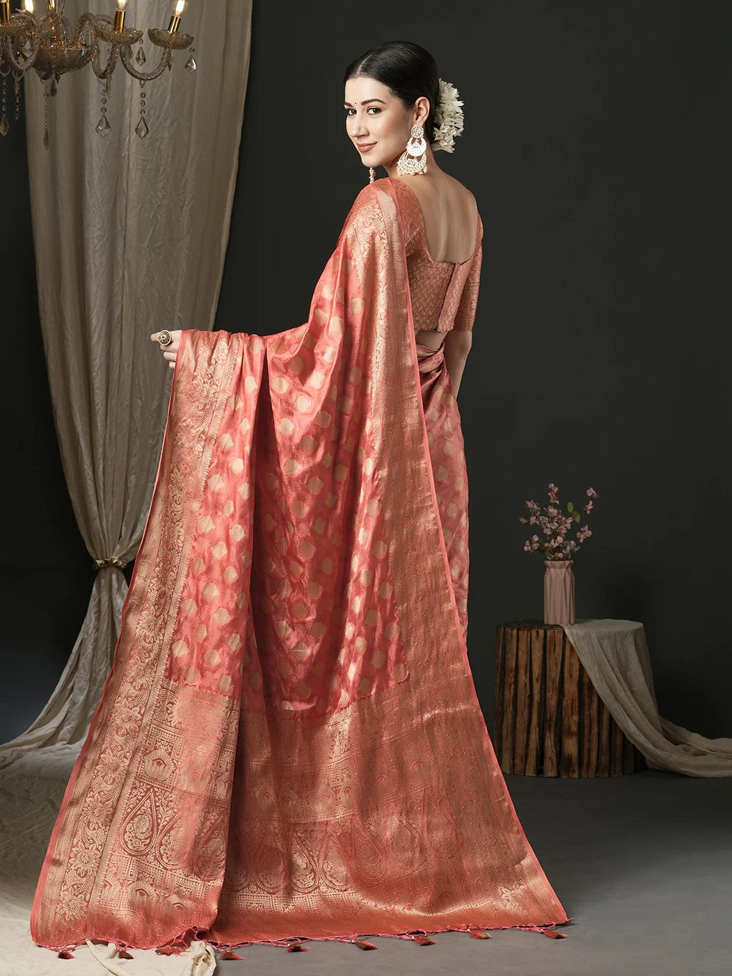 Tarani back view peach satin silk saree showing rich zari pallu design