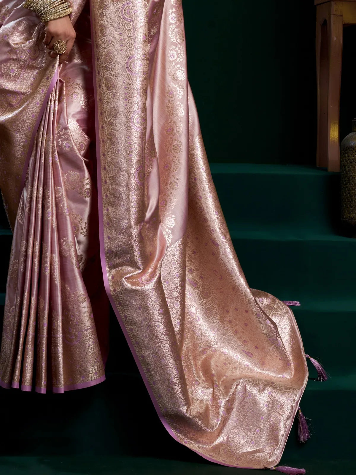 Tarani satin saree fabric closeup showing intricate zari and tassel details