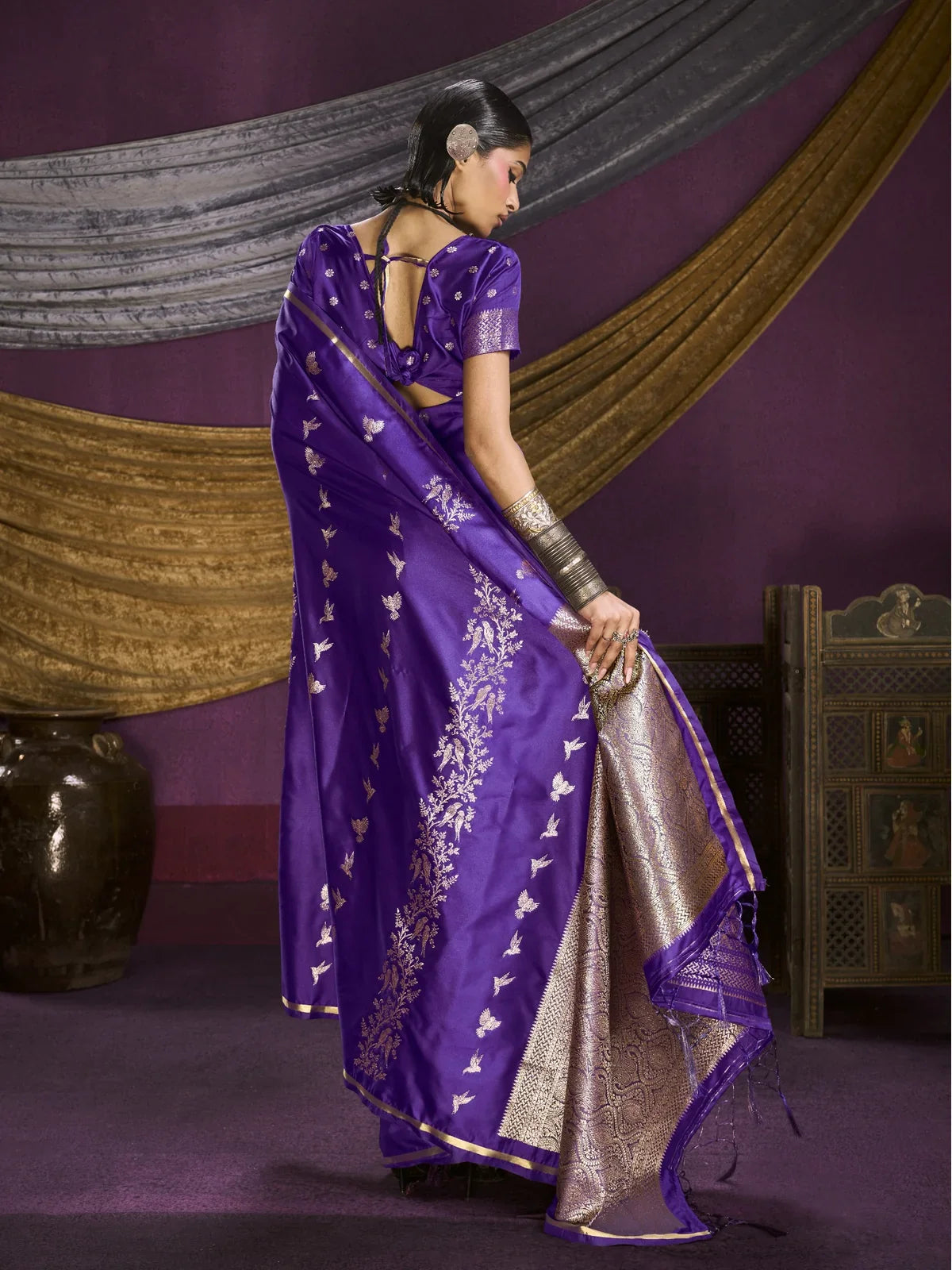 Tarani back view of purple satin saree showing blouse design and pallu drape