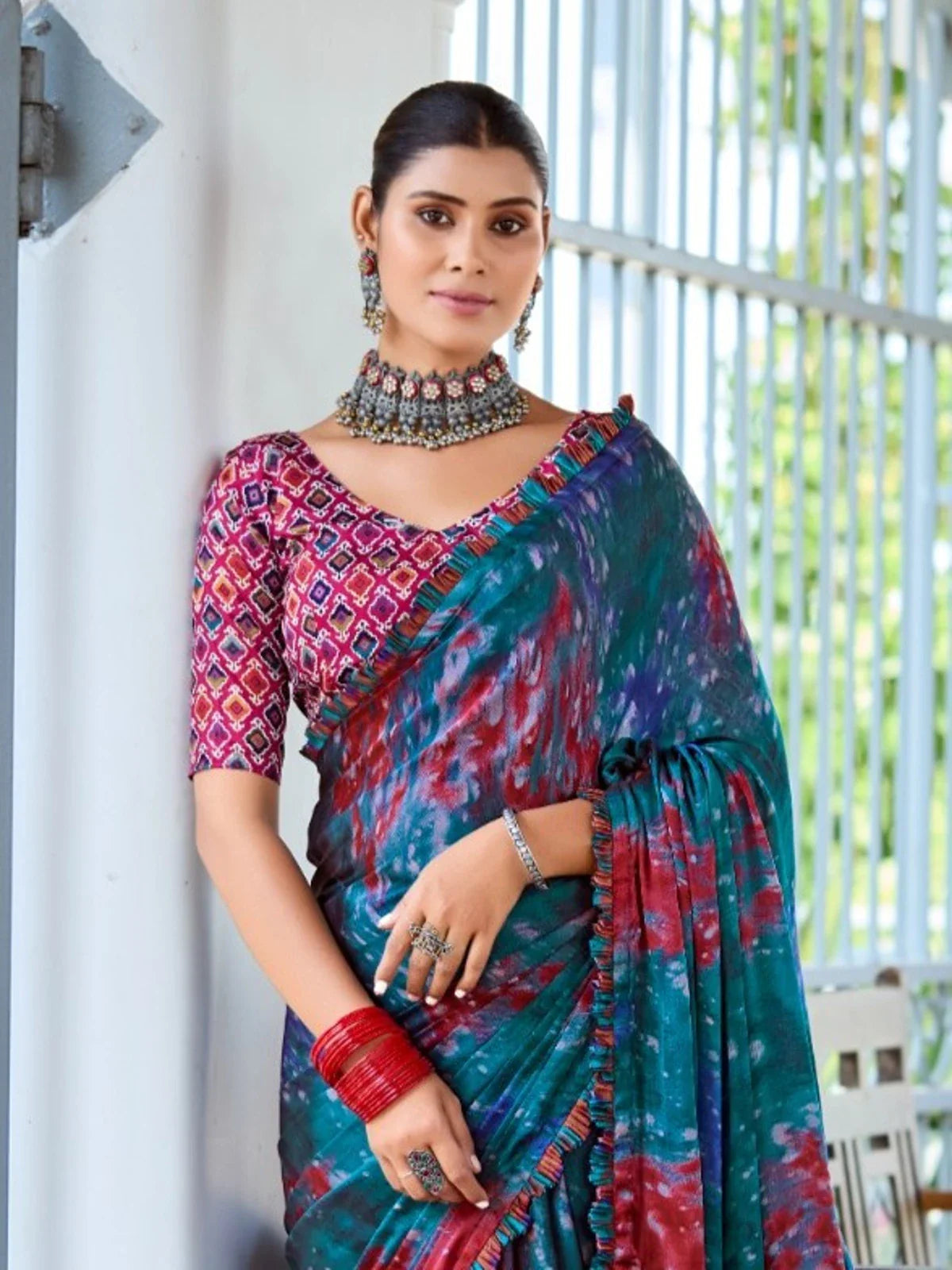 Tarani teal satin saree upper body view showing designer blouse and jewelry