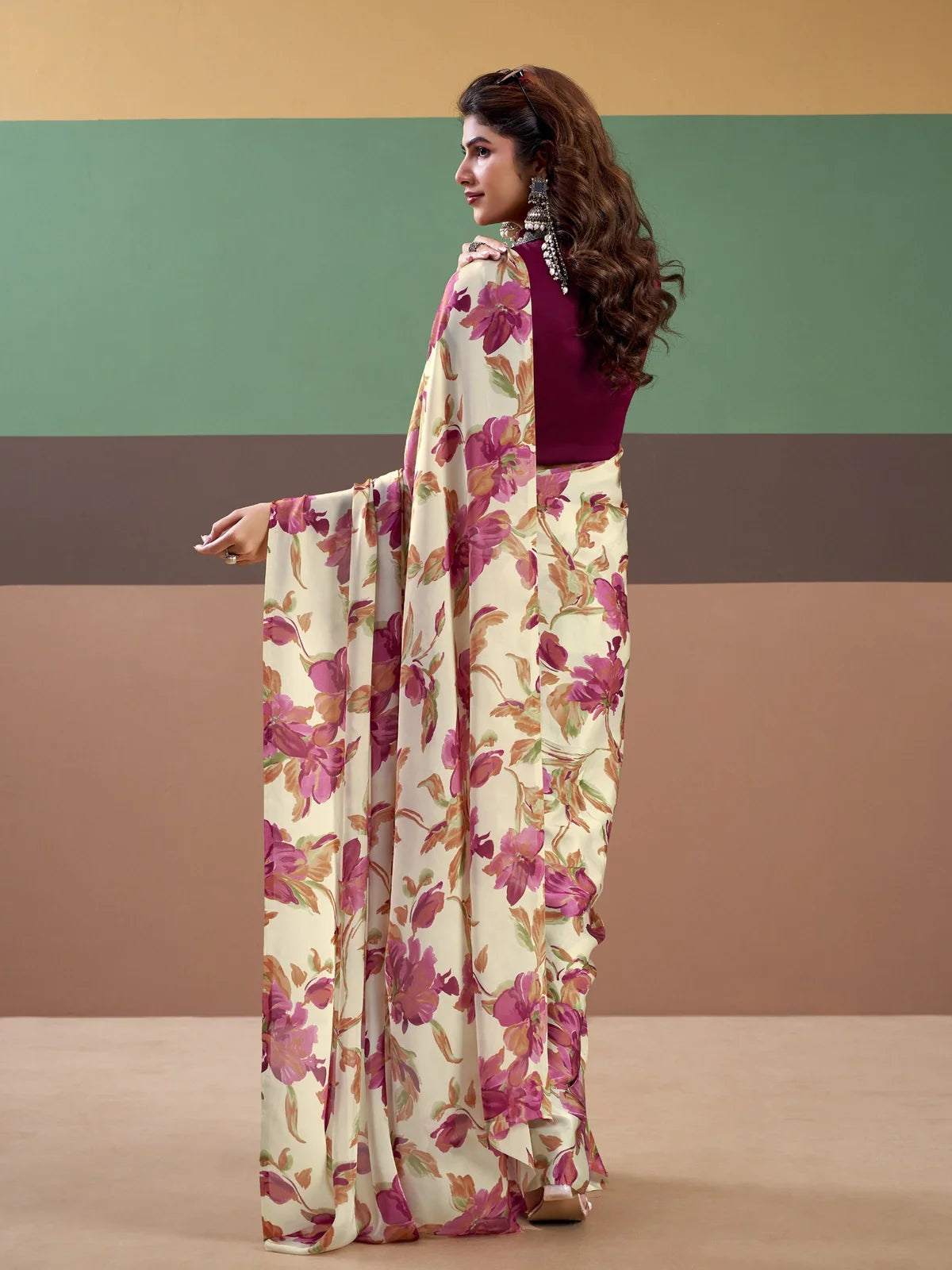 Tarani back view of cream floral satin silk saree paired with stitched blouse