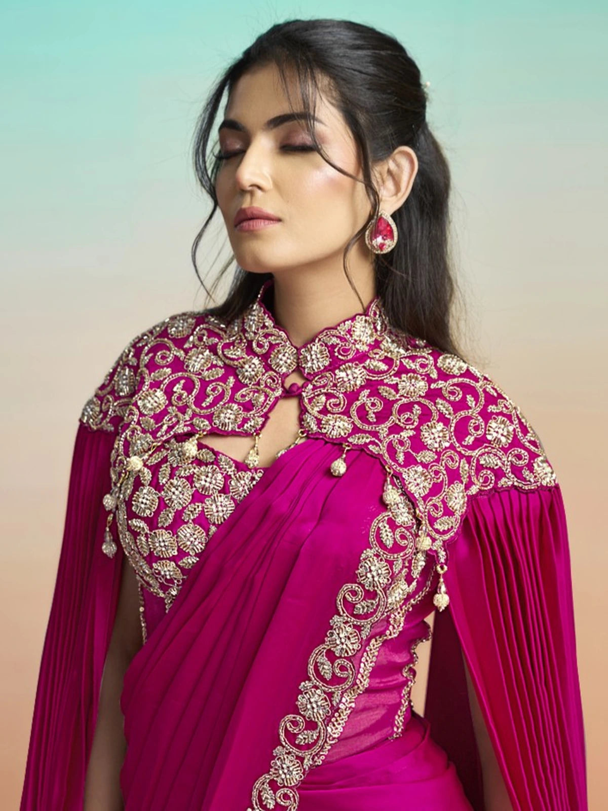 Tarani Shrishti magenta saree blouse view with ornate zardosi corset and pleated designer cape