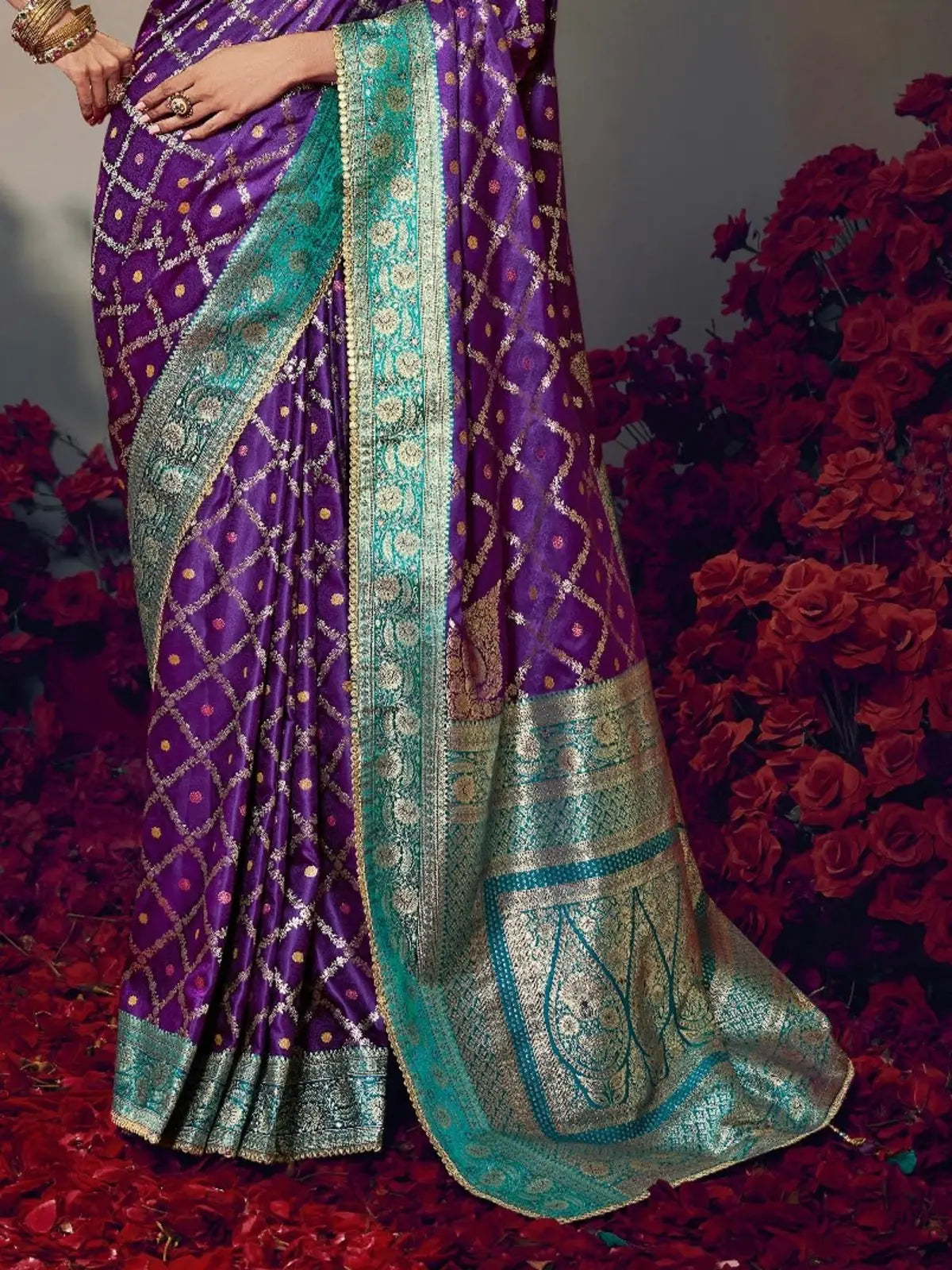Tarani purple satin silk saree pallu close-up with rich zari work and turquoise detailing