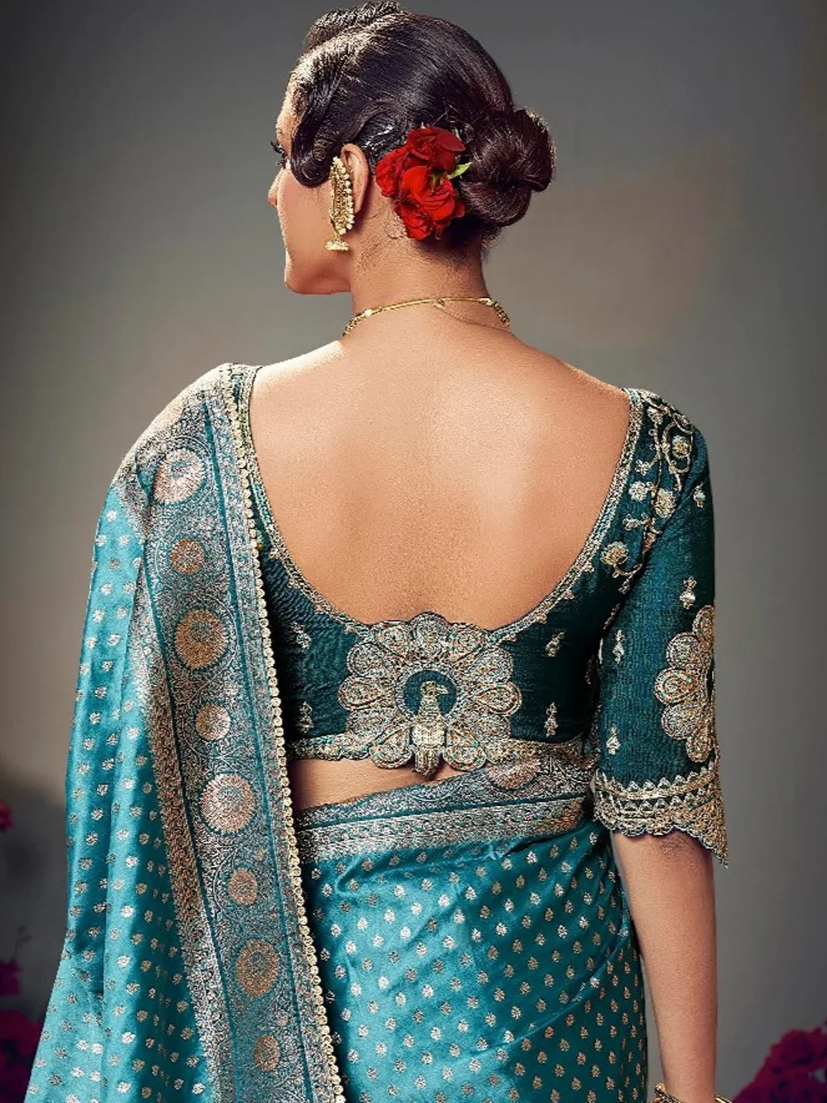 Tarani teal satin silk saree back blouse design with floral embroidery and deep cut