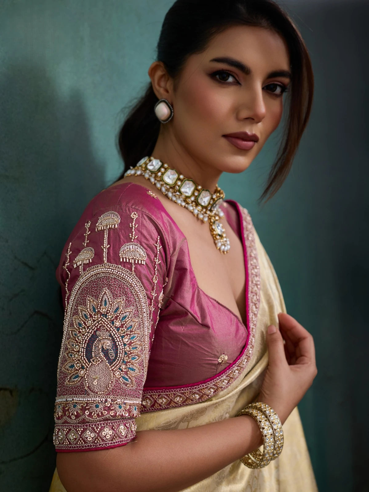 Tarani blouse closeup view with handcrafted sleeve embroidery on golden tissue Banarasi saree