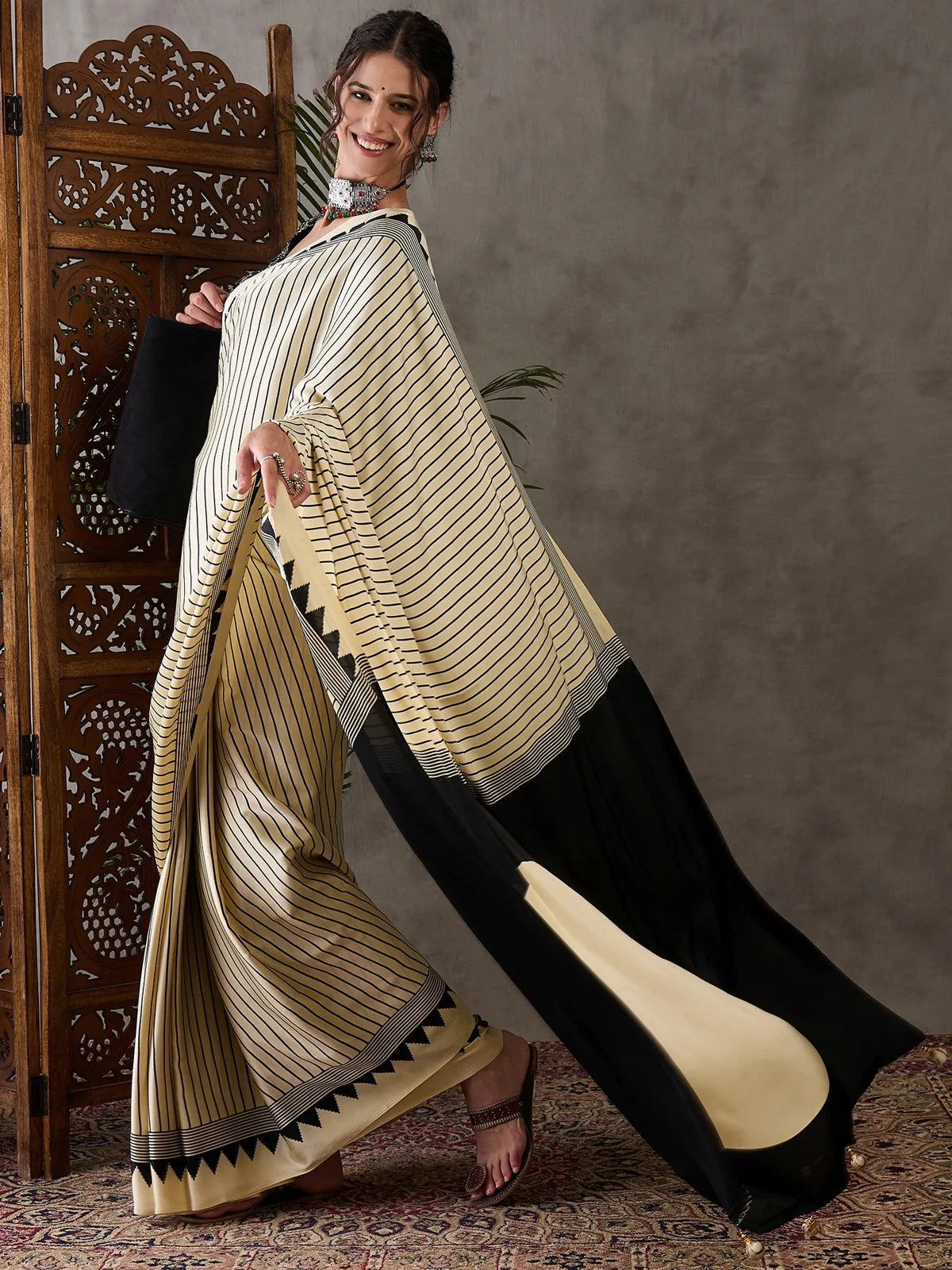 Tarani semi modal satin saree side pose highlighting elegant drape