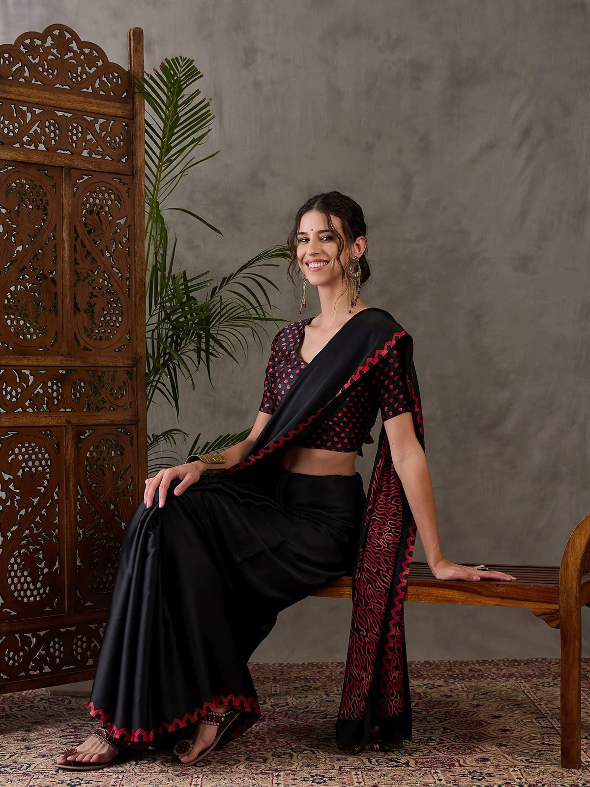 Tarani black festival wear saree front seated view with printed blouse