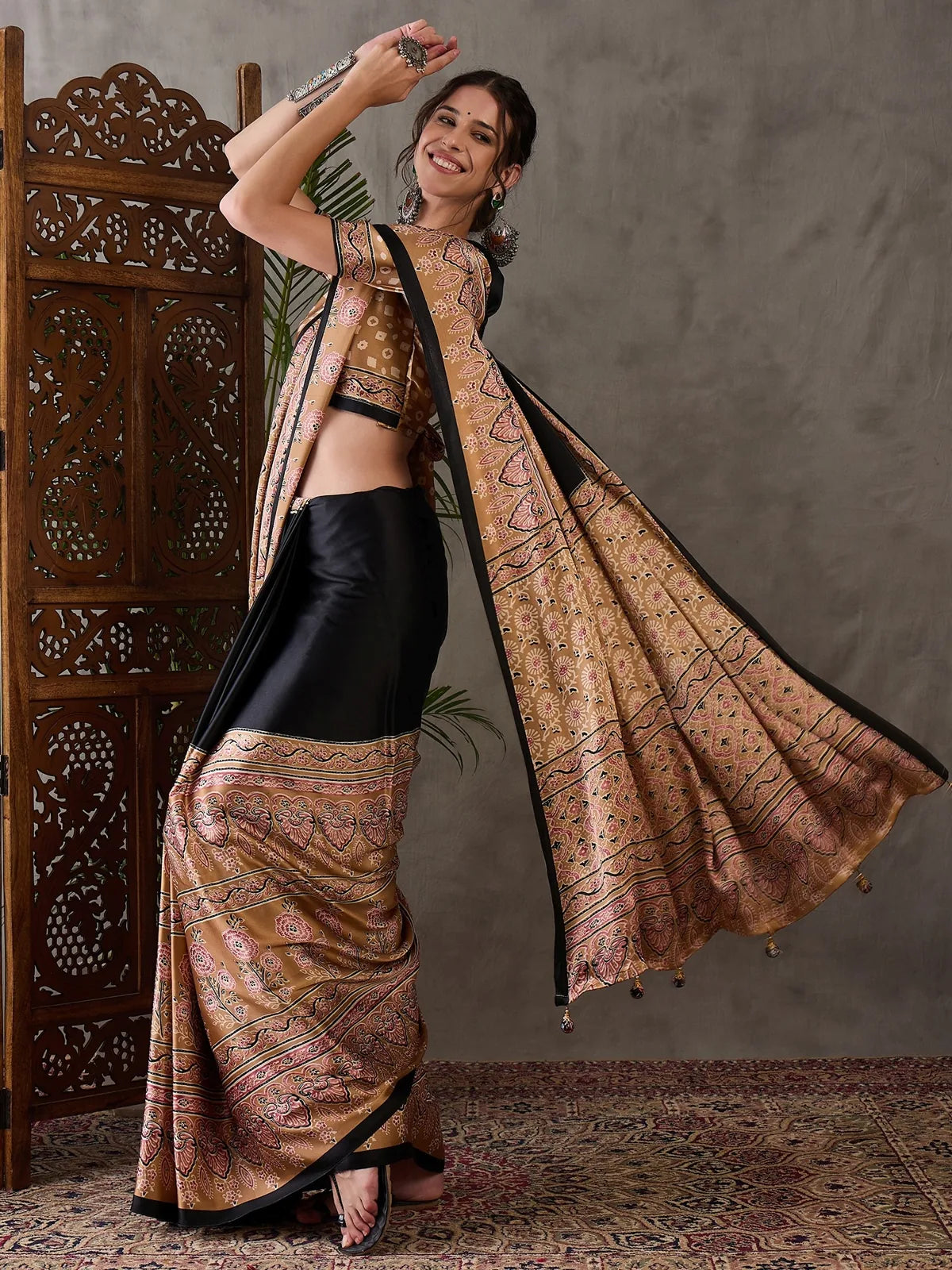 Tarani Dharika black semi modal satin printed saree flowing pallu side pose festival wear