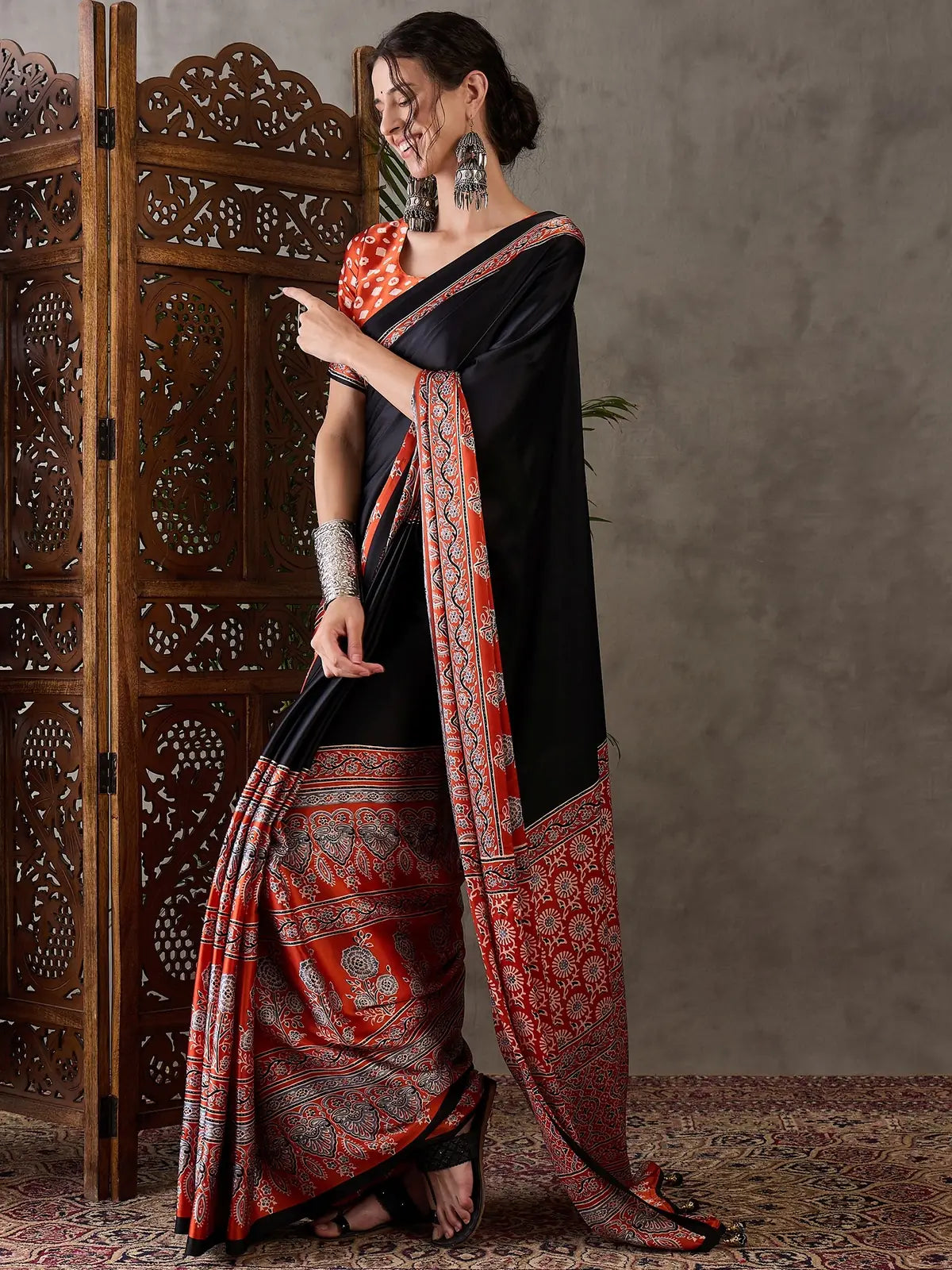 Tarani black party wear saree side pose with printed pallu and blouse piece