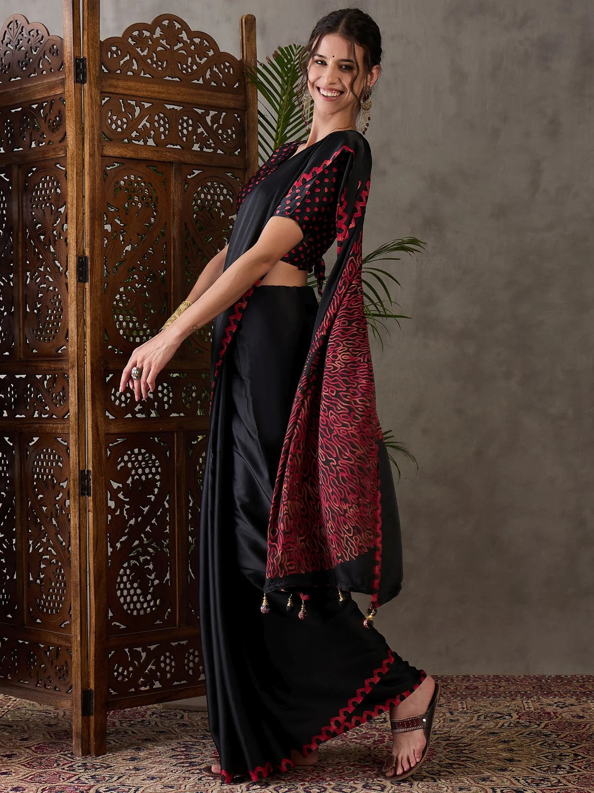 Tarani black semi modal satin saree side view with statement pallu