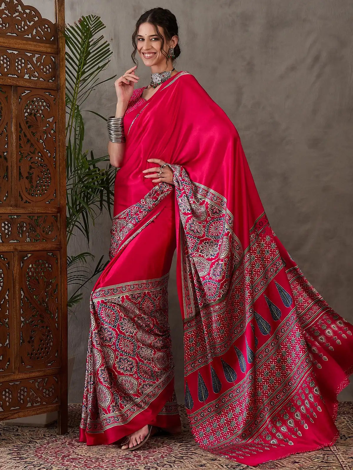 Tarani Aishvi side pose in magenta semi modal satin printed saree